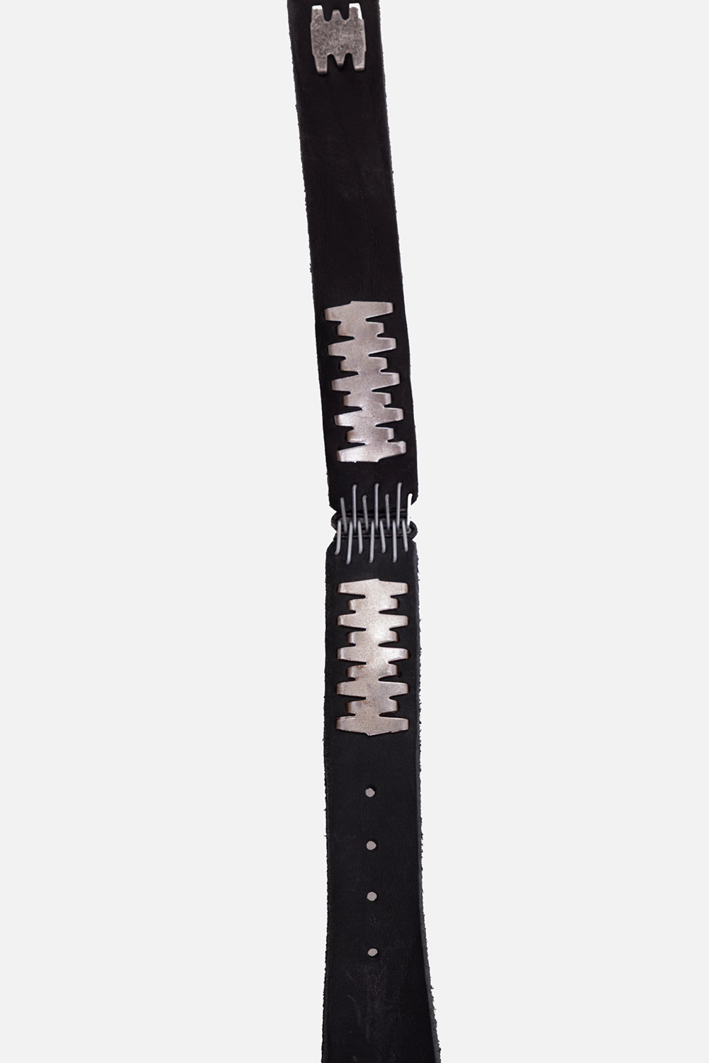Isaac Sellam calf leather belt in black, hardware close-up with silver staple plates and wire spine connector
