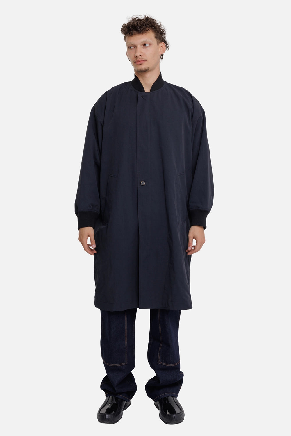 Uma Wang men's navy Cane coat, full-length on-model view with oversized fit, ribbed cuffs and welt pockets