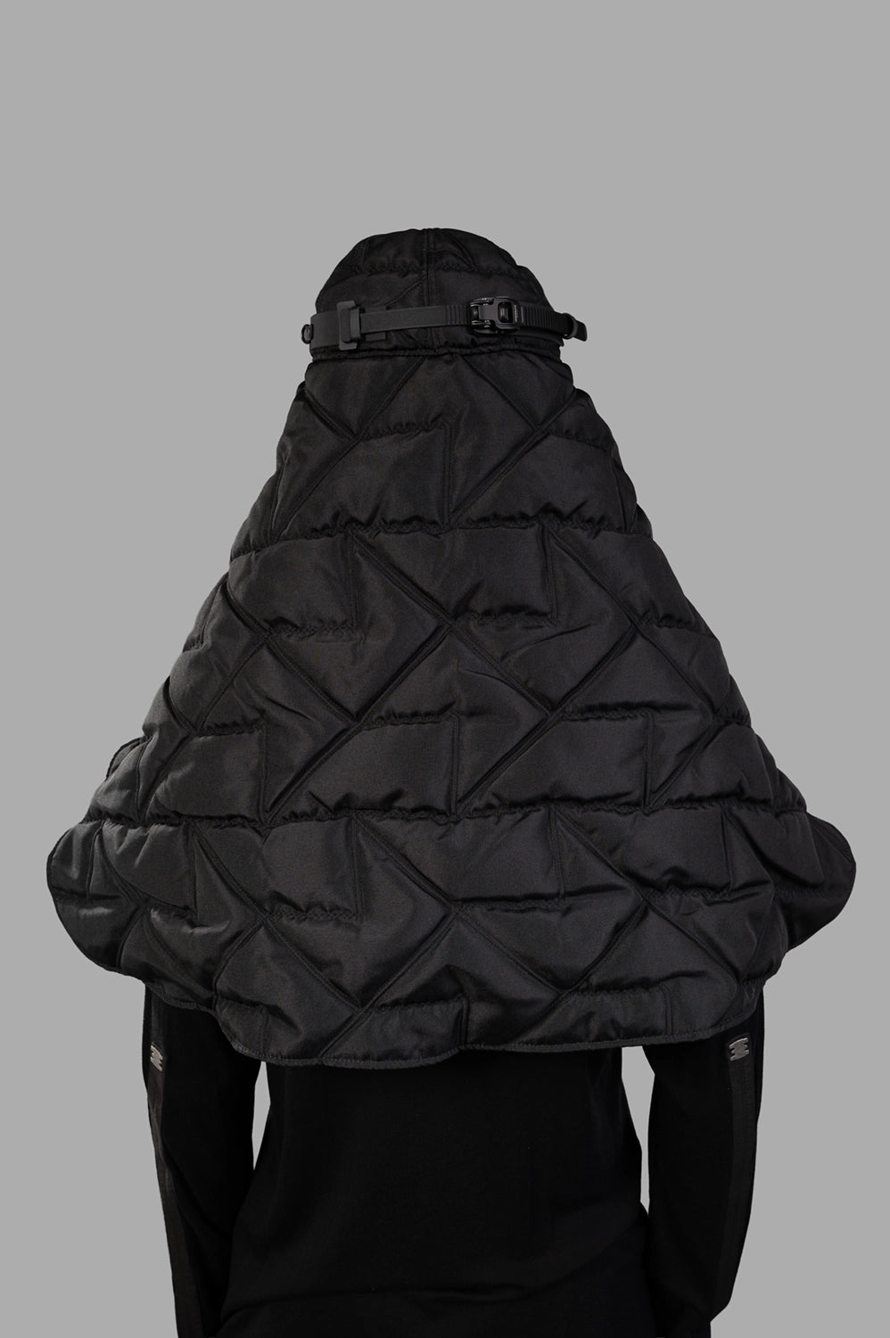 Back view of quilted veil cap with geometric stitching and adjustable buckle strap