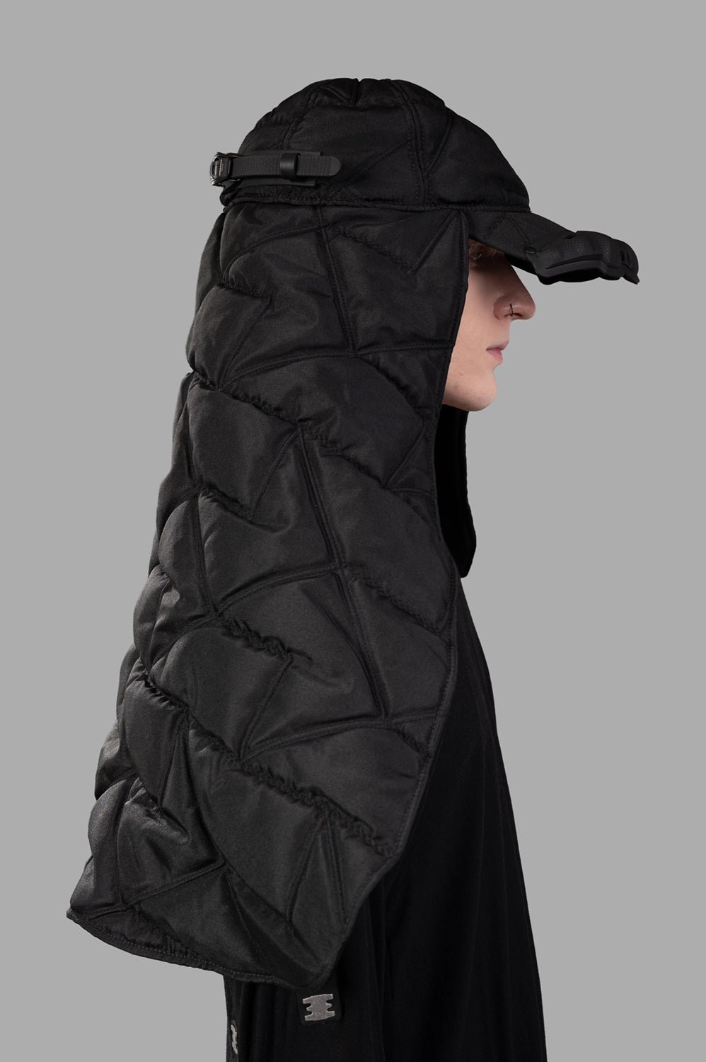 Front close-up of puffer scarf cap showing curved brim, molded visor and quilted veil