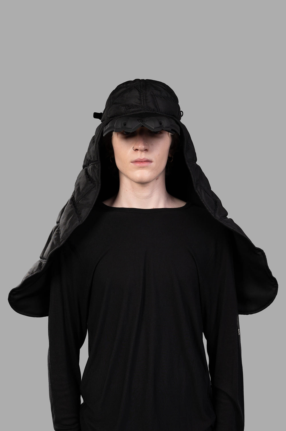 Model wearing black puffer scarf cap with quilted veil, full-length front view