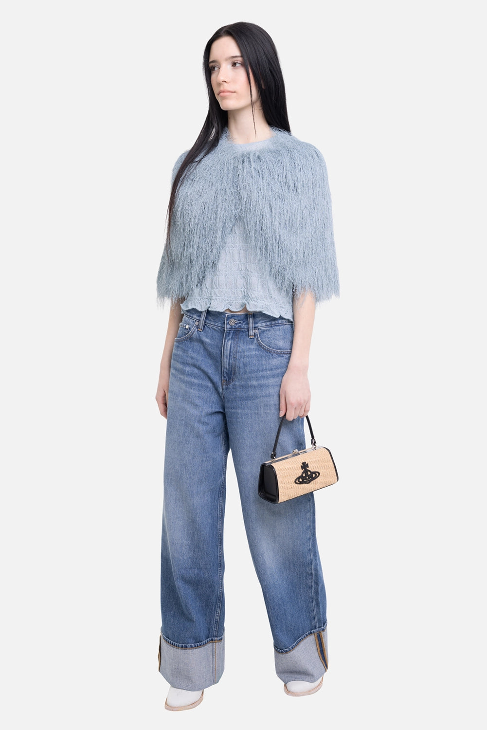 By Malene Birger women’s cape in Arona Blue, on model full length, all-over fringe over a pale blue top
