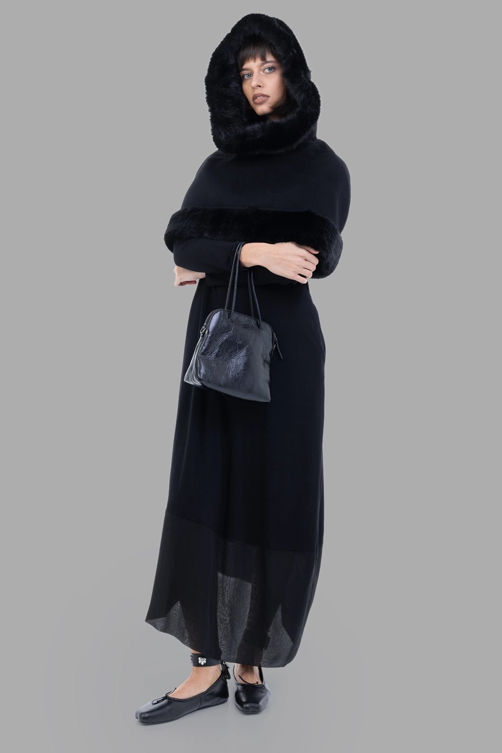 By Malene Birger women cape in black, on-model full length, hooded with faux-fur trim.