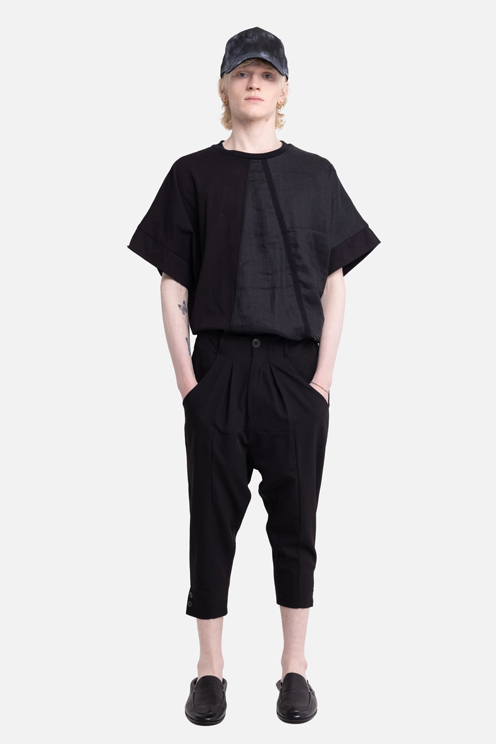La Haine Inside Us men's capri trousers in black, on-model full-length, cropped hems with side buttons