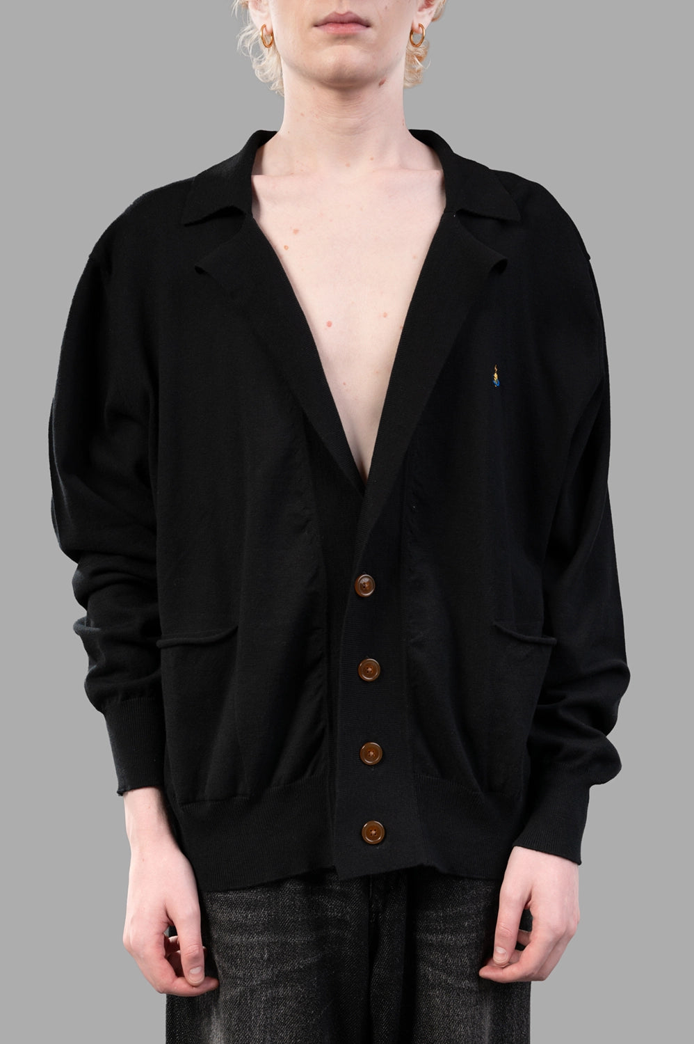Vivienne Westwood cardigan in black, on-model half length, notched collar, patch pockets and amber buttons