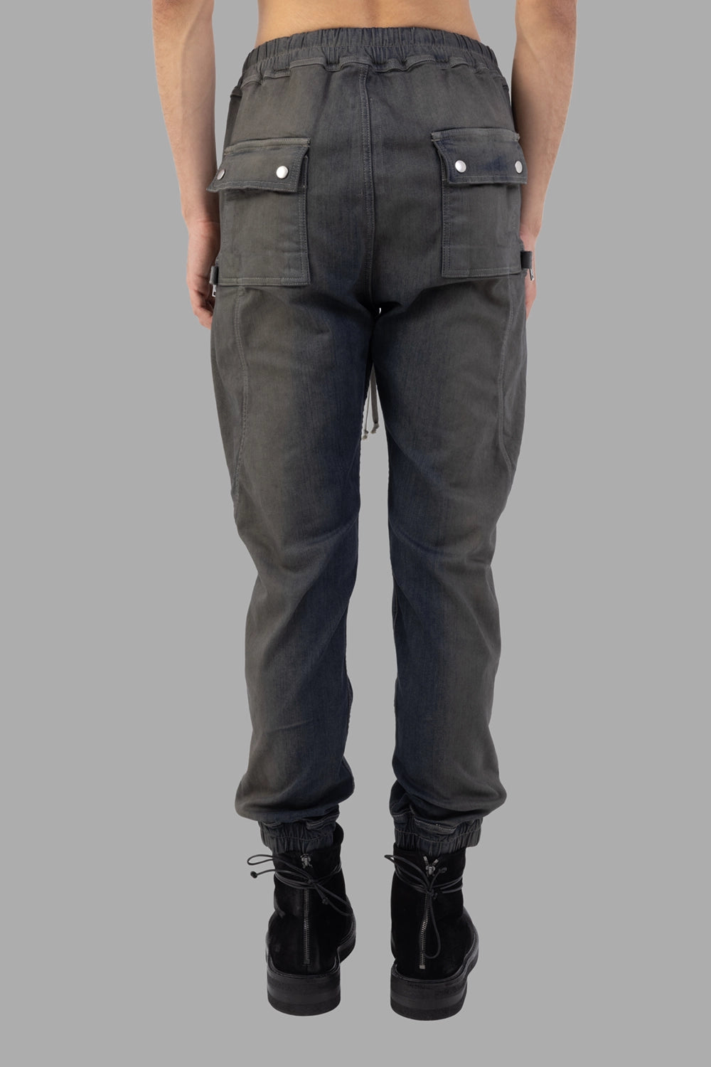 Rick Owens cargo pants in Darkdust Degrade, back view, flap back pockets with snaps and elasticated hems