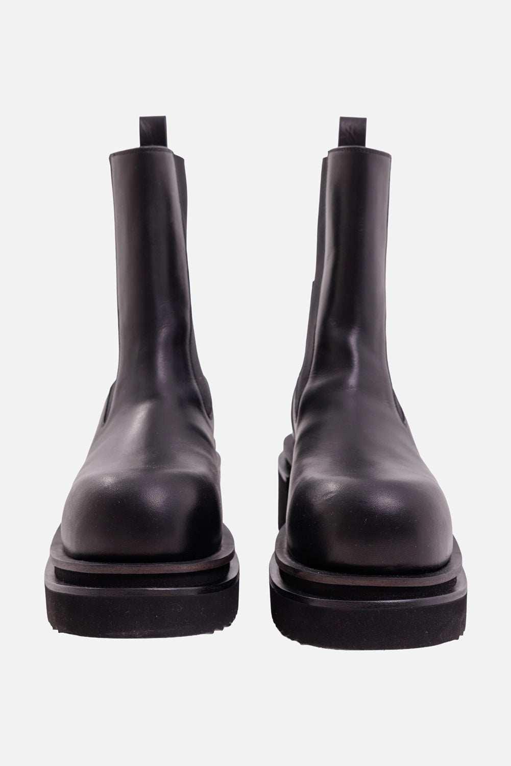 Rick Owens men's Chelsea boots in black, front view with rounded toes and layered lug platforms