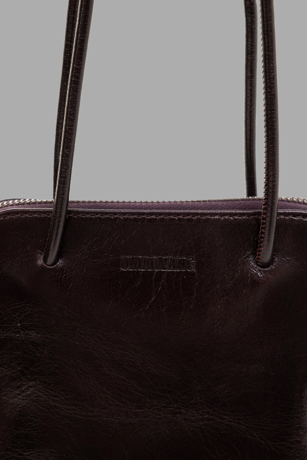 Uma Wang women's clutch bag in wine, logo detail, debossed branding and leather zip pull