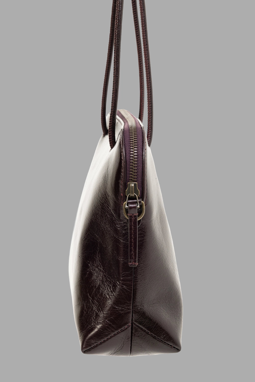 Uma Wang women's clutch bag in wine, side view, antique-brass zip and slim handles