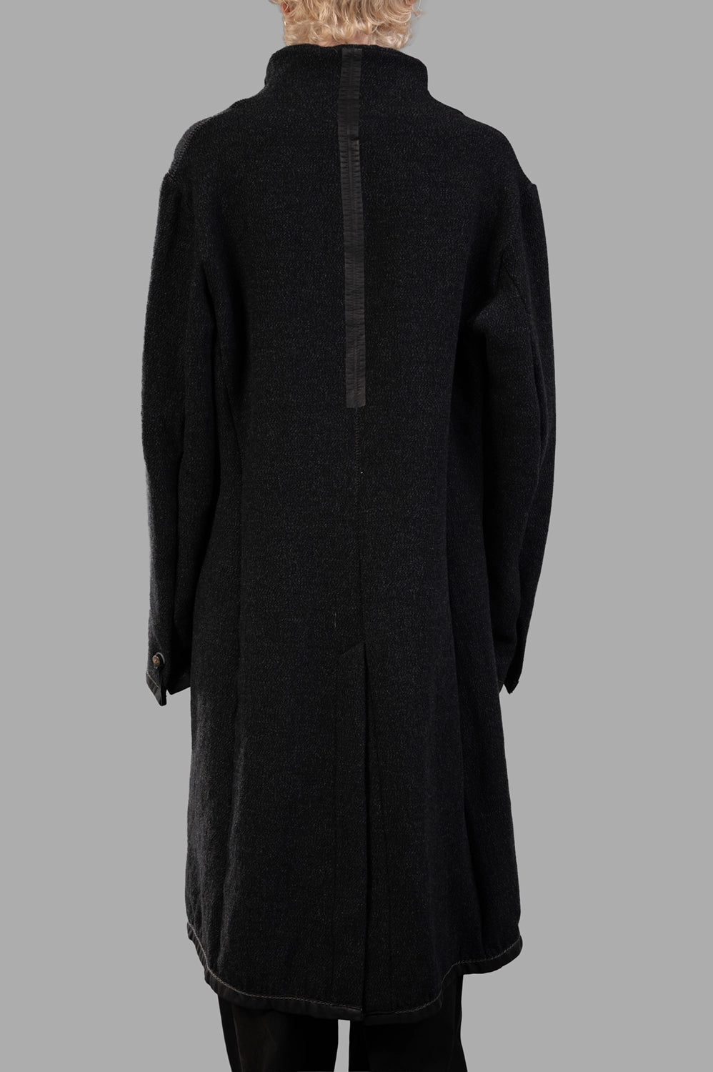 69 by Isaac Sellam coat in black, back view, vertical leather spine and back vent