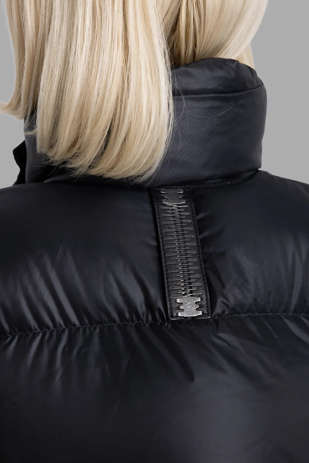 Isaac Sellam Experience unisex black coat, collar detail, high padded neckline with metal-stapled back tab.