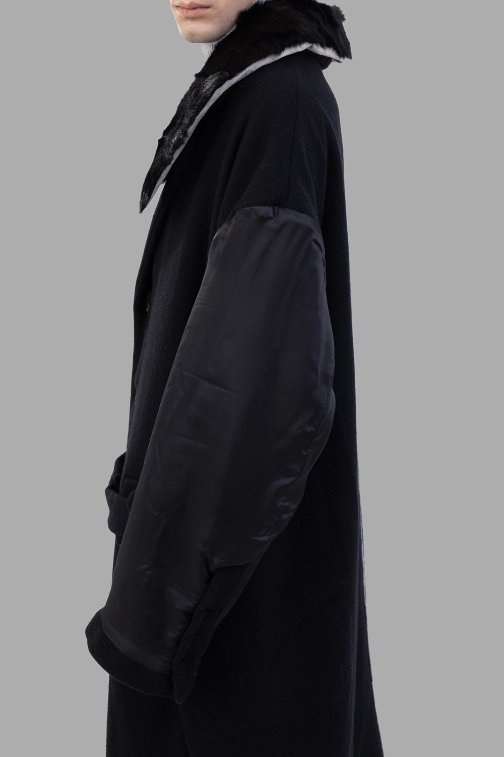 Giovanni Cavagna coat in black, side view, contrast satin sleeve volume