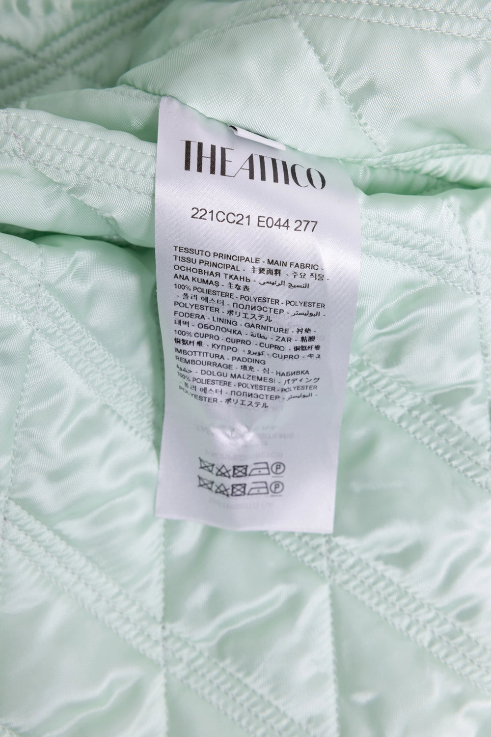 Pre-owned The Attico women's coat in mint green, care tag close-up with fabric composition details