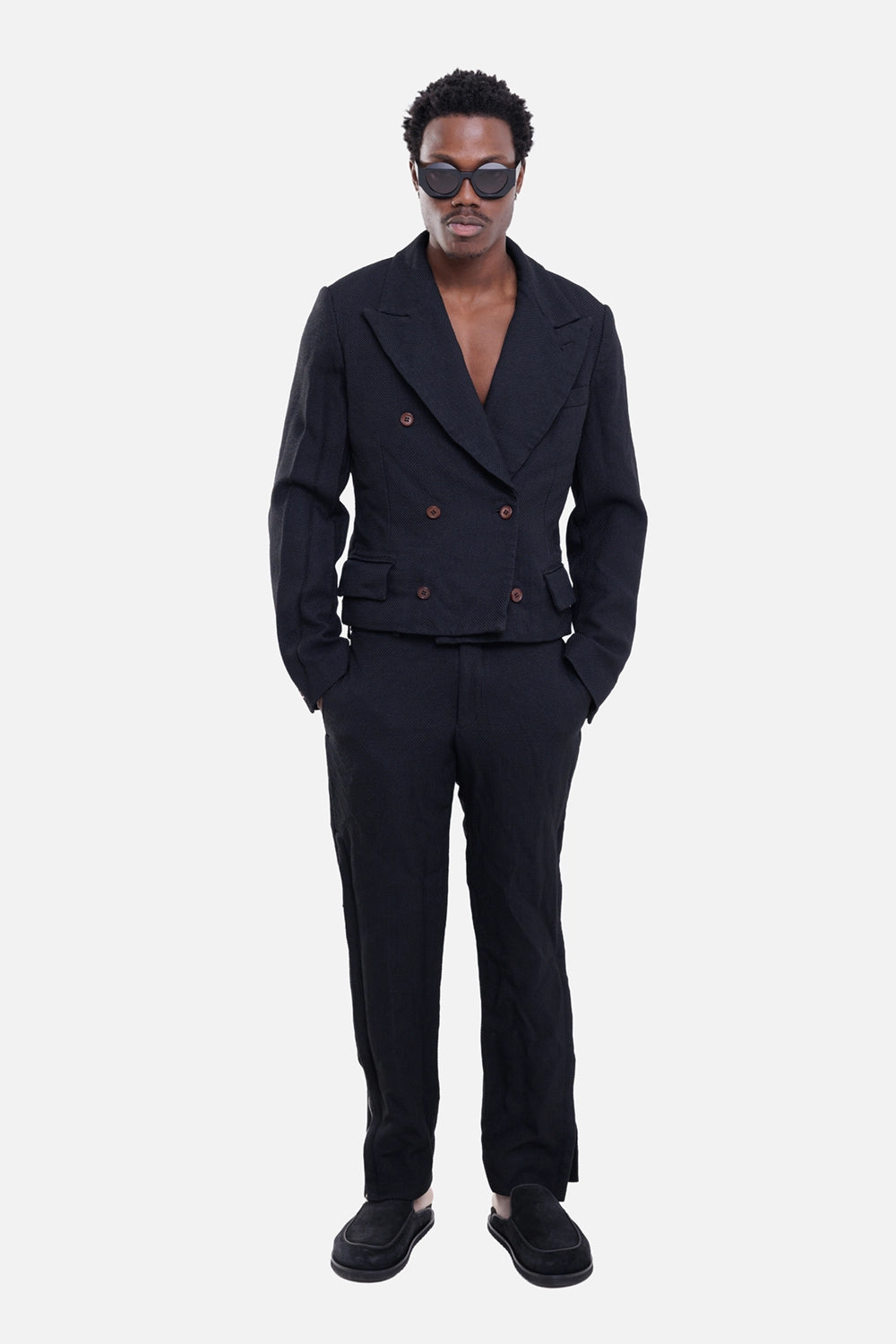 Comme des Garçons men's blazer in black, on-model full-length view, cropped double-breasted front and brown buttons