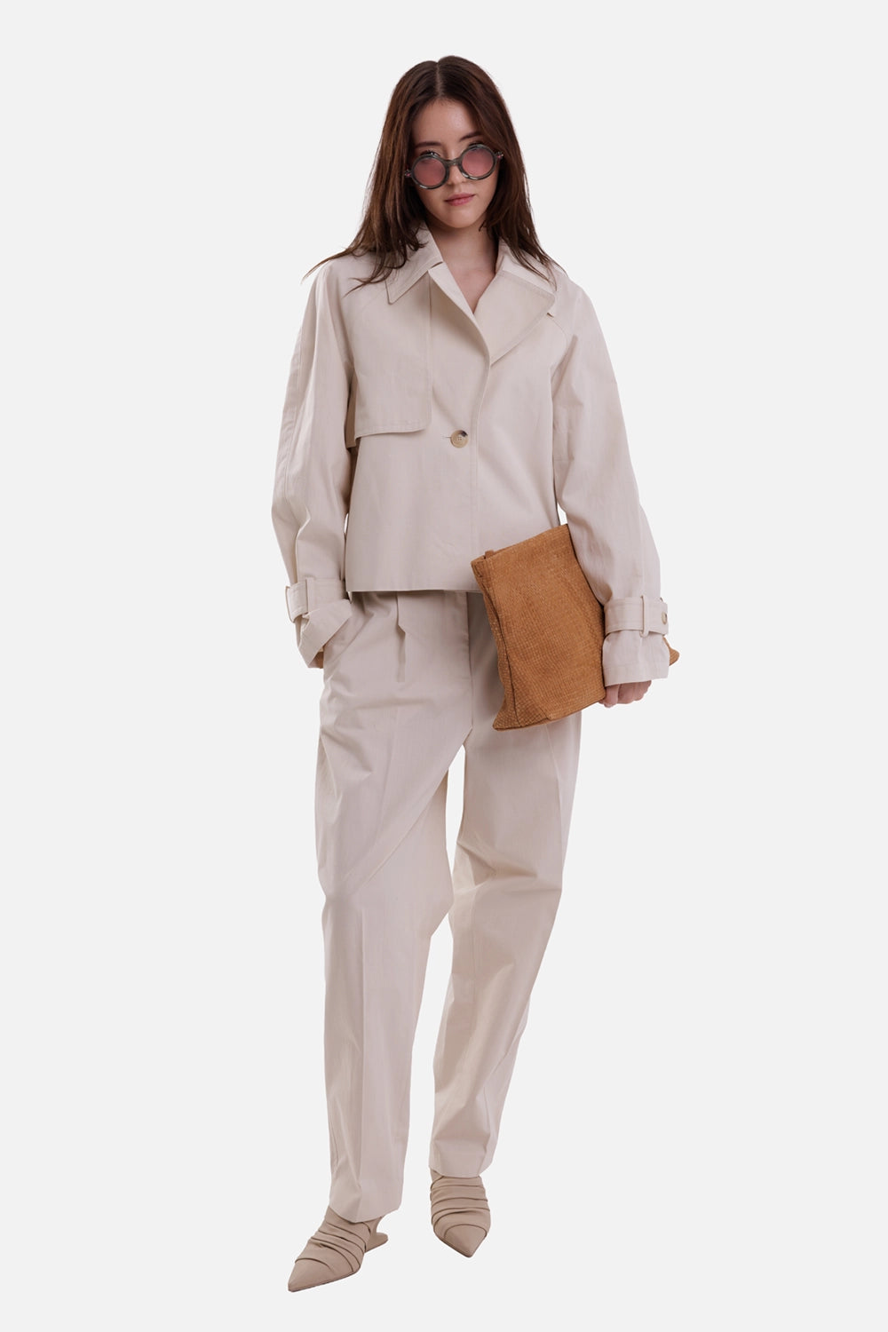 Joseph women's cropped trench jacket in Sandstone, full-length model view with wide lapels and buttoned cuff tabs