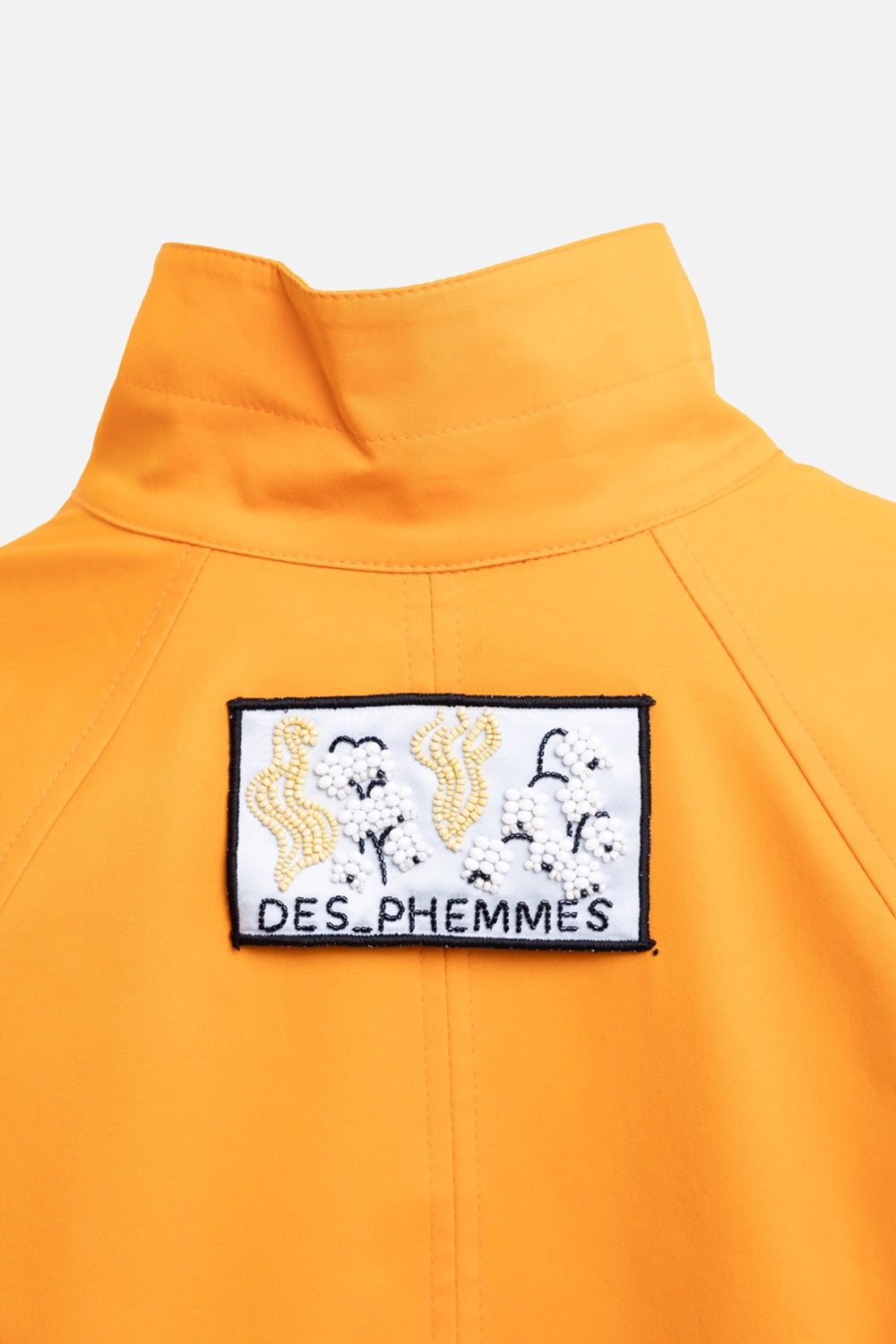 DES PHEMMES women's cropped trenchcoat in tangerine, logo detail, beaded back patch and stand collar
