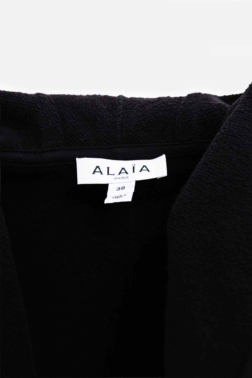 Alaïa women's cropped wraparound hoodie in black, label detail, Paris tag and terry interior