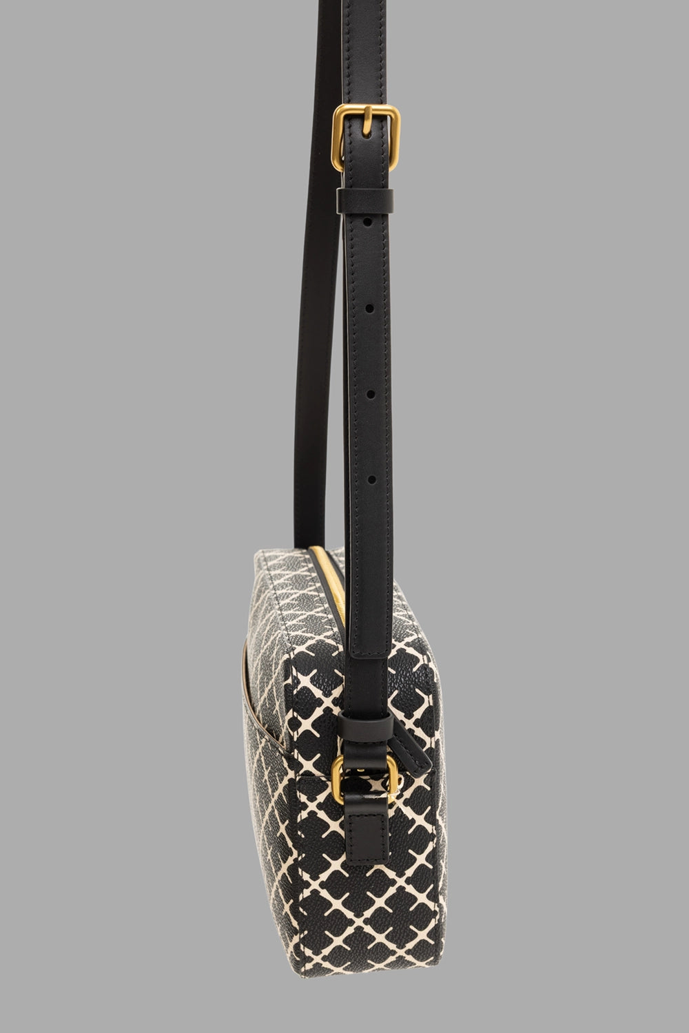 By Malene Birger women's crossbody bag in black, side view, adjustable strap with gold-tone buckle