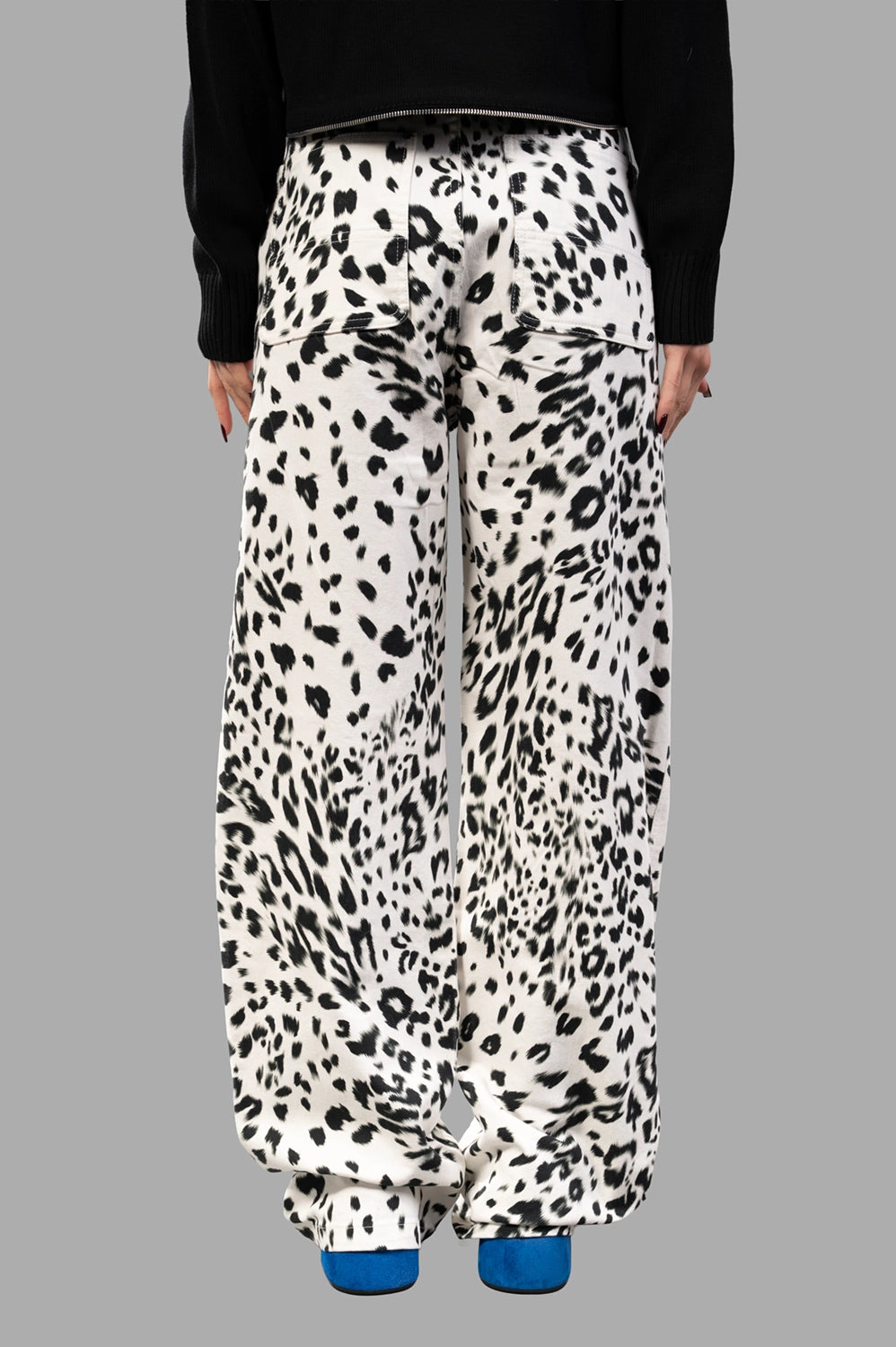 Back close-up showing patch pockets and wide leg drape in leopard print