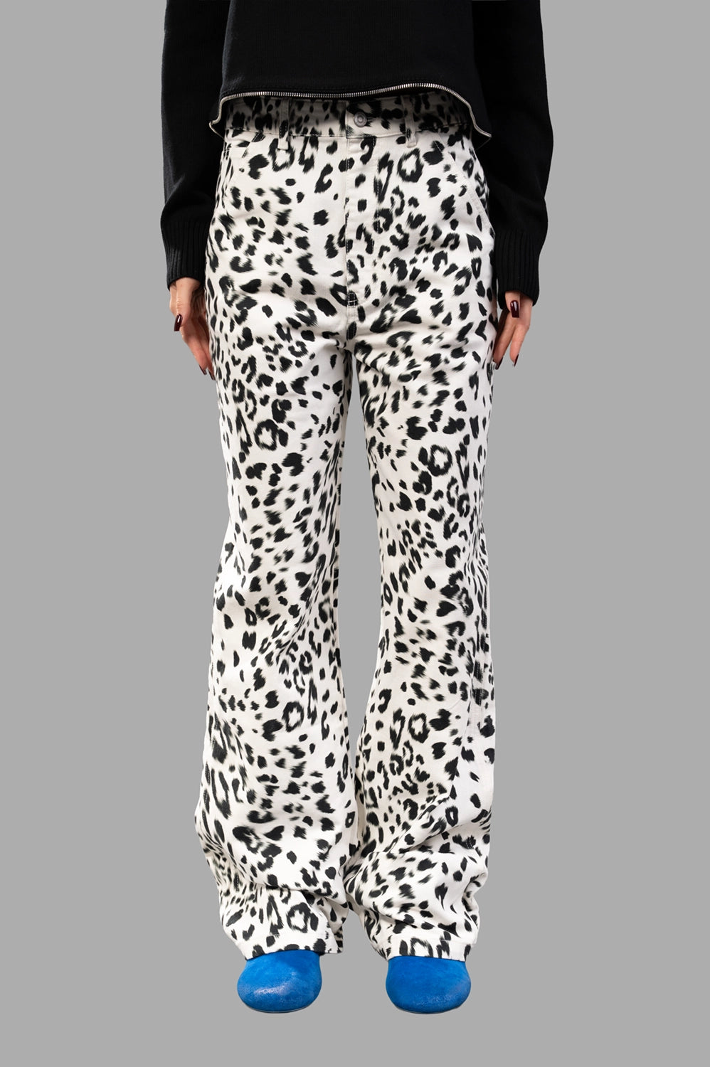 Front close-up showing waistband with belt loops, button and zip fly, all-over animal print