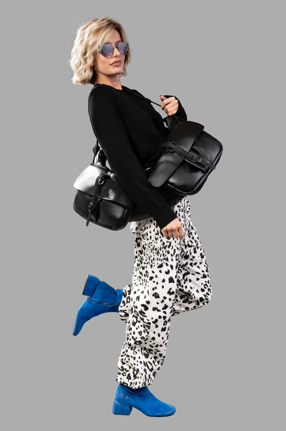 Full-length view of leopard-print cargo pants in creme and black, relaxed wide leg, belt loops at waist