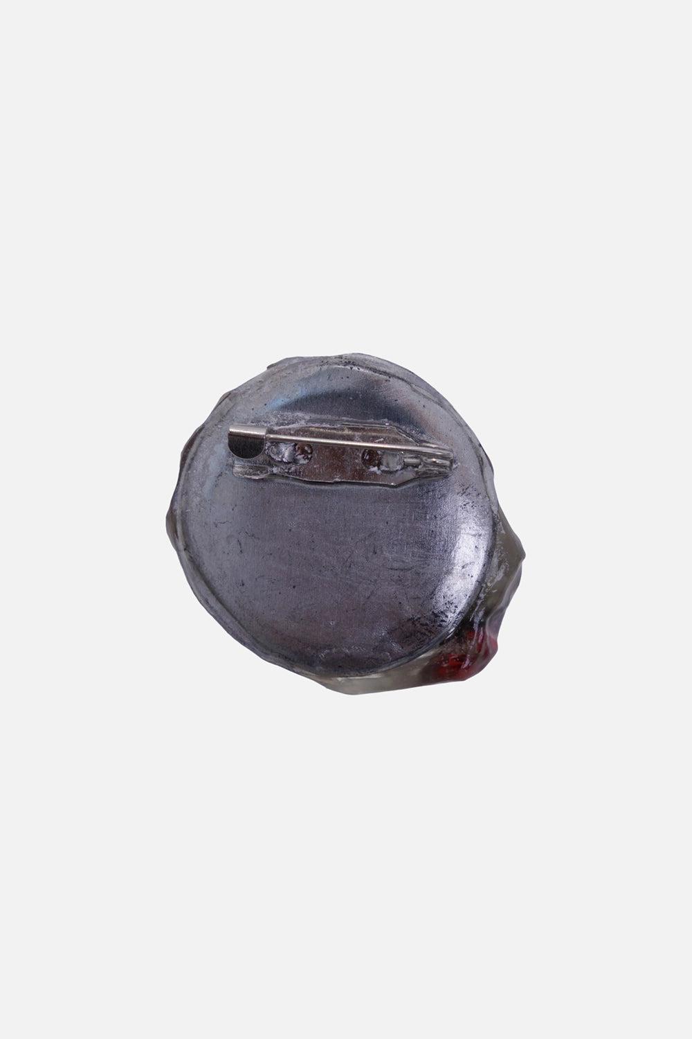 Jinko unisex dog-head brooch in clear, back view with silver-tone plate and horizontal pin fastening