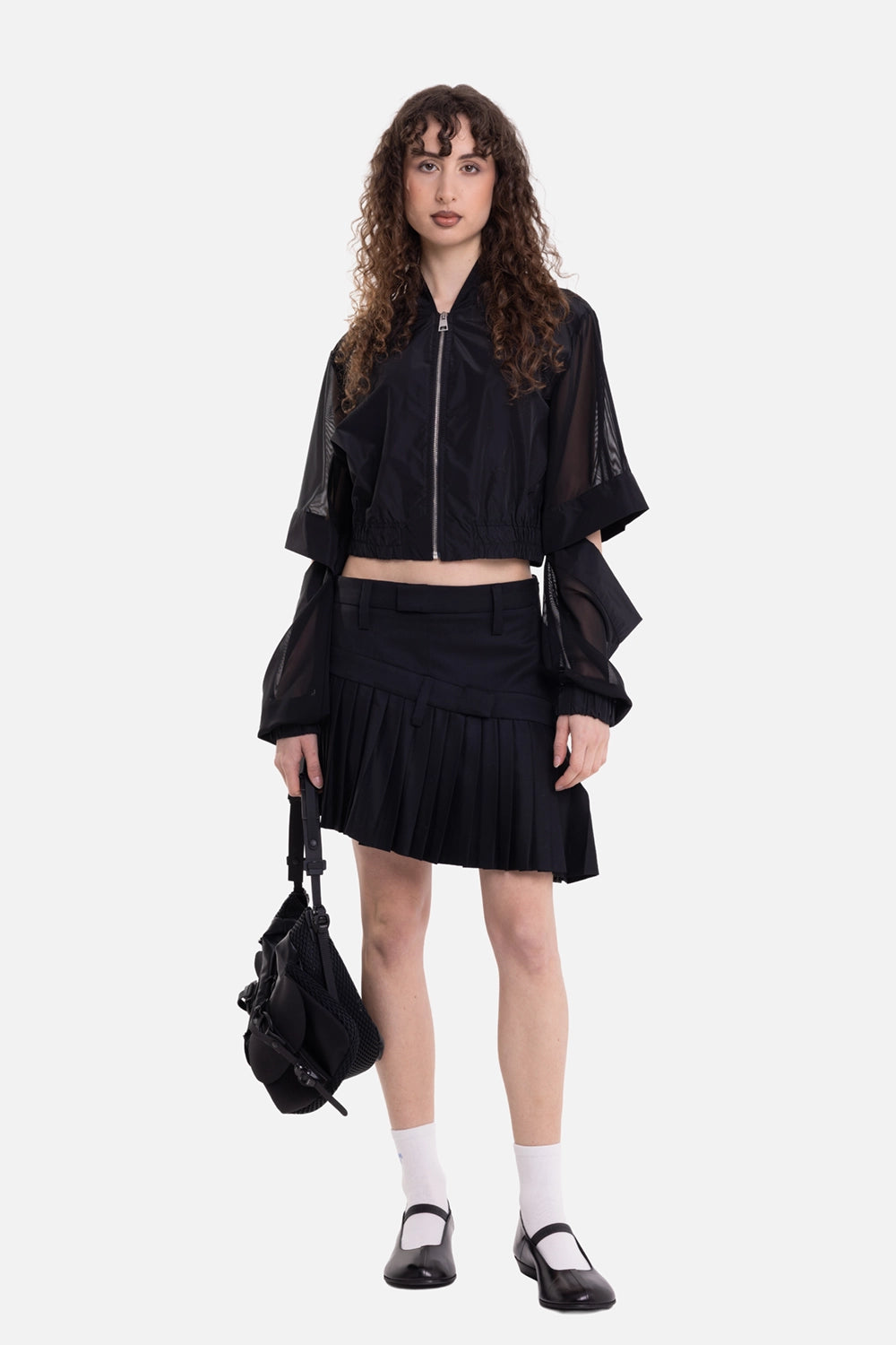 Torisheju women's double pleated mini skirt in black, on-model full length with asymmetric pleats