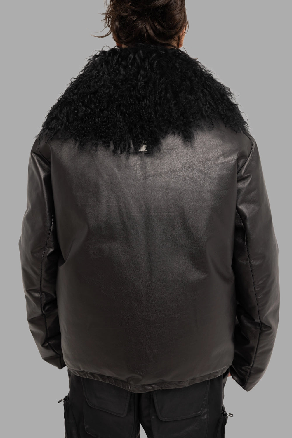 Isaac Sellam Experience unisex down jacket in black, back view, dramatic shearling collar drape and smooth shell