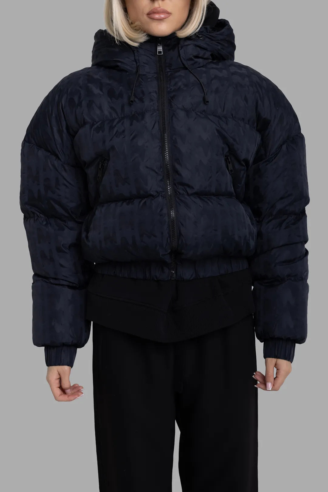 MSGM women's black logo-jacquard down jacket, close front view, hood with drawcord and slanted zipped pockets.