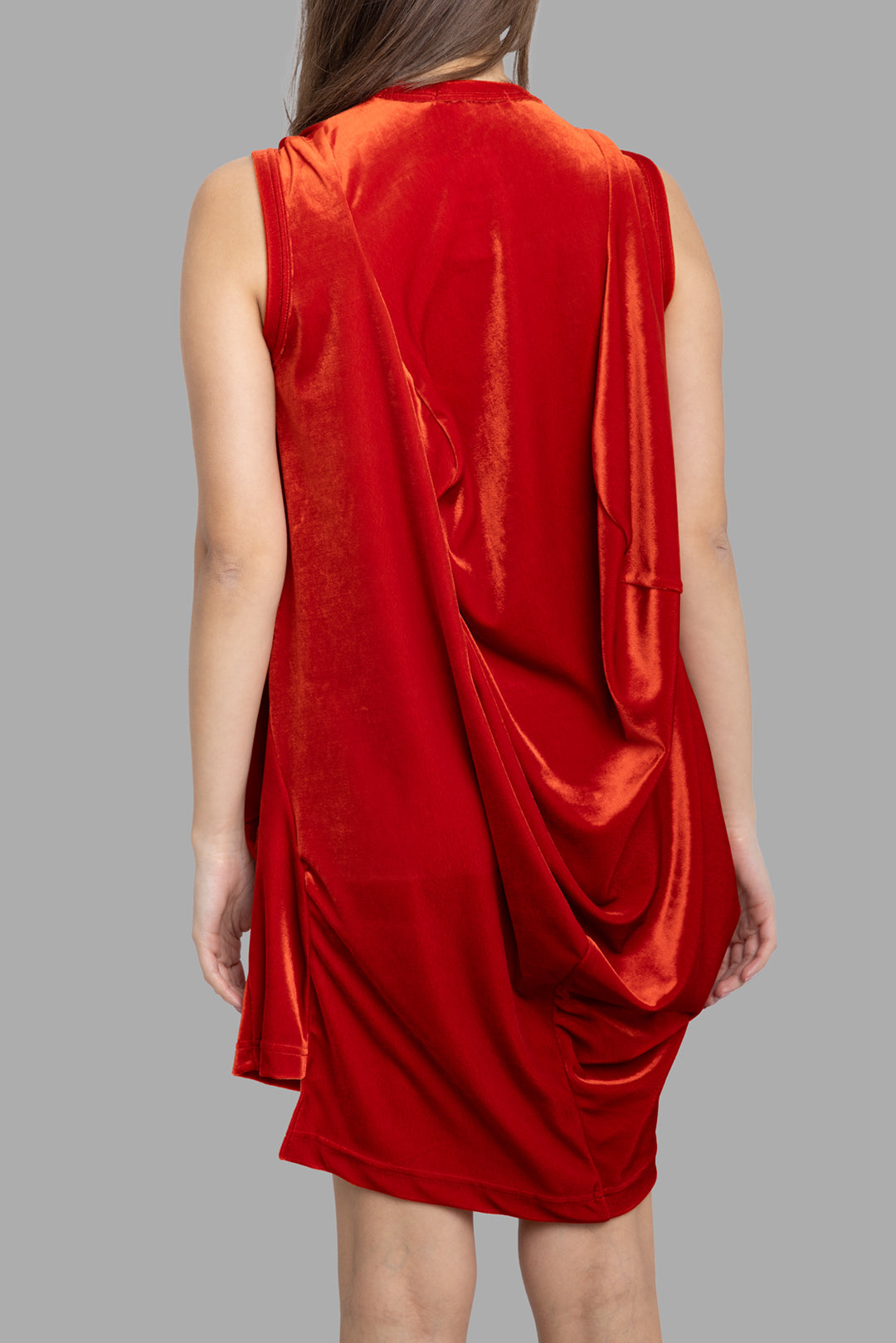 Comme des Garçons women's draped mini dress in red, back view, smooth fabric with cascading drape detail toward hem.