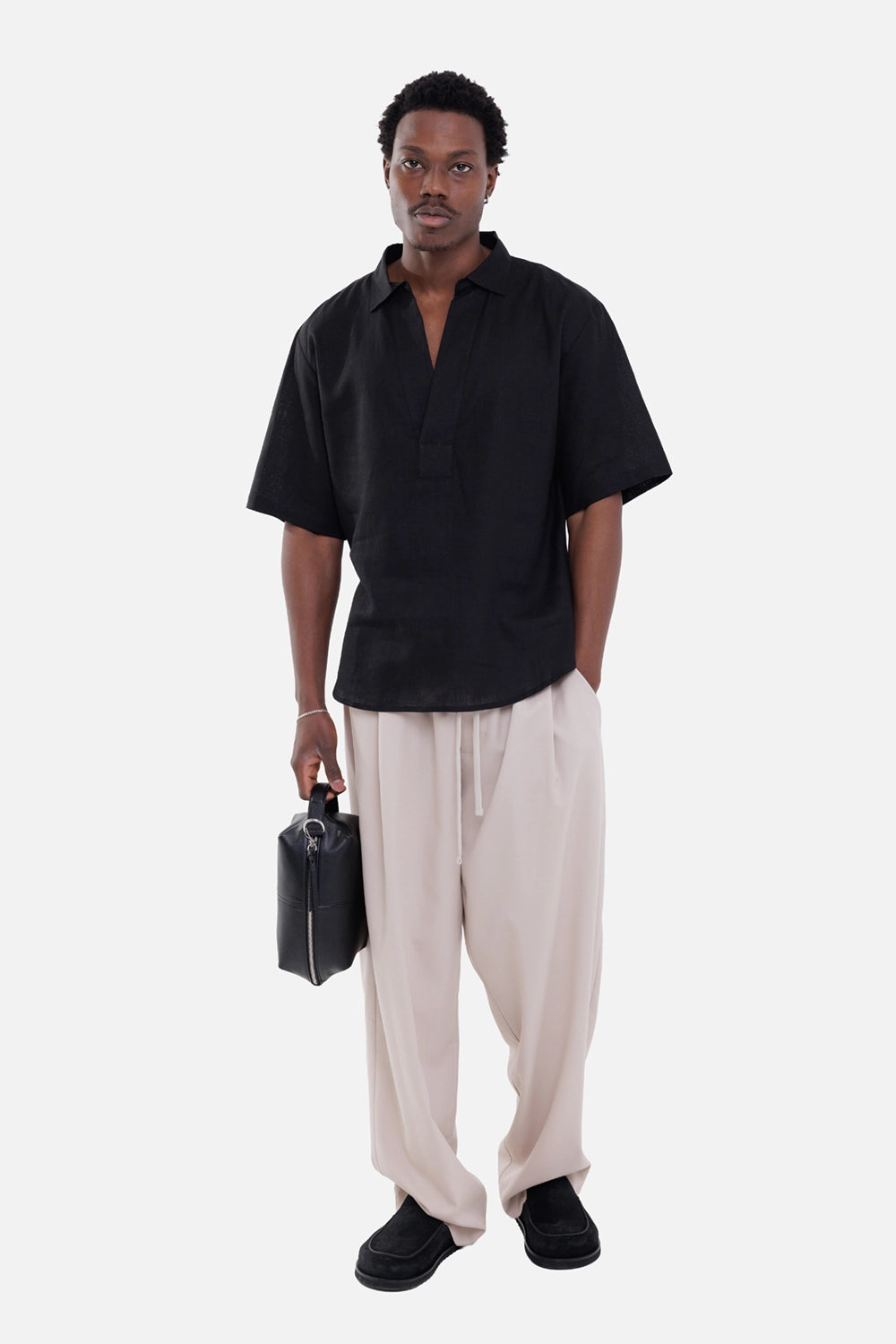 Gaëlle Paris men's trousers in beige, on-model full-length view, drawstring waist and fluid relaxed leg