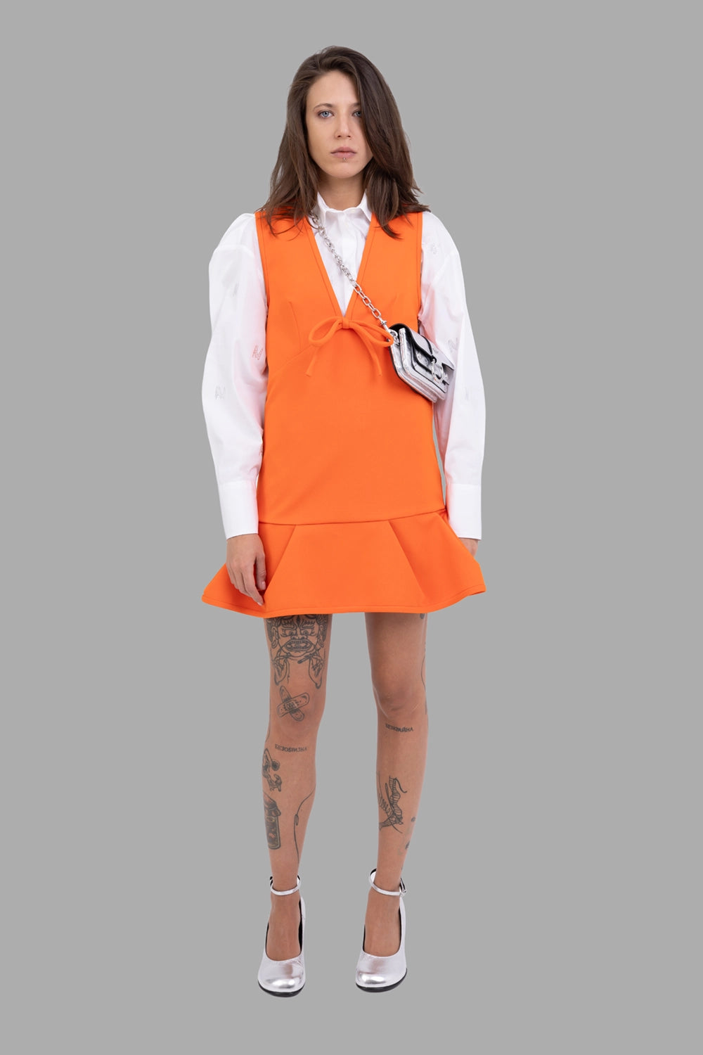 MSGM women dress in orange, on-model full length, deep V-neck with front bow, flounced hem