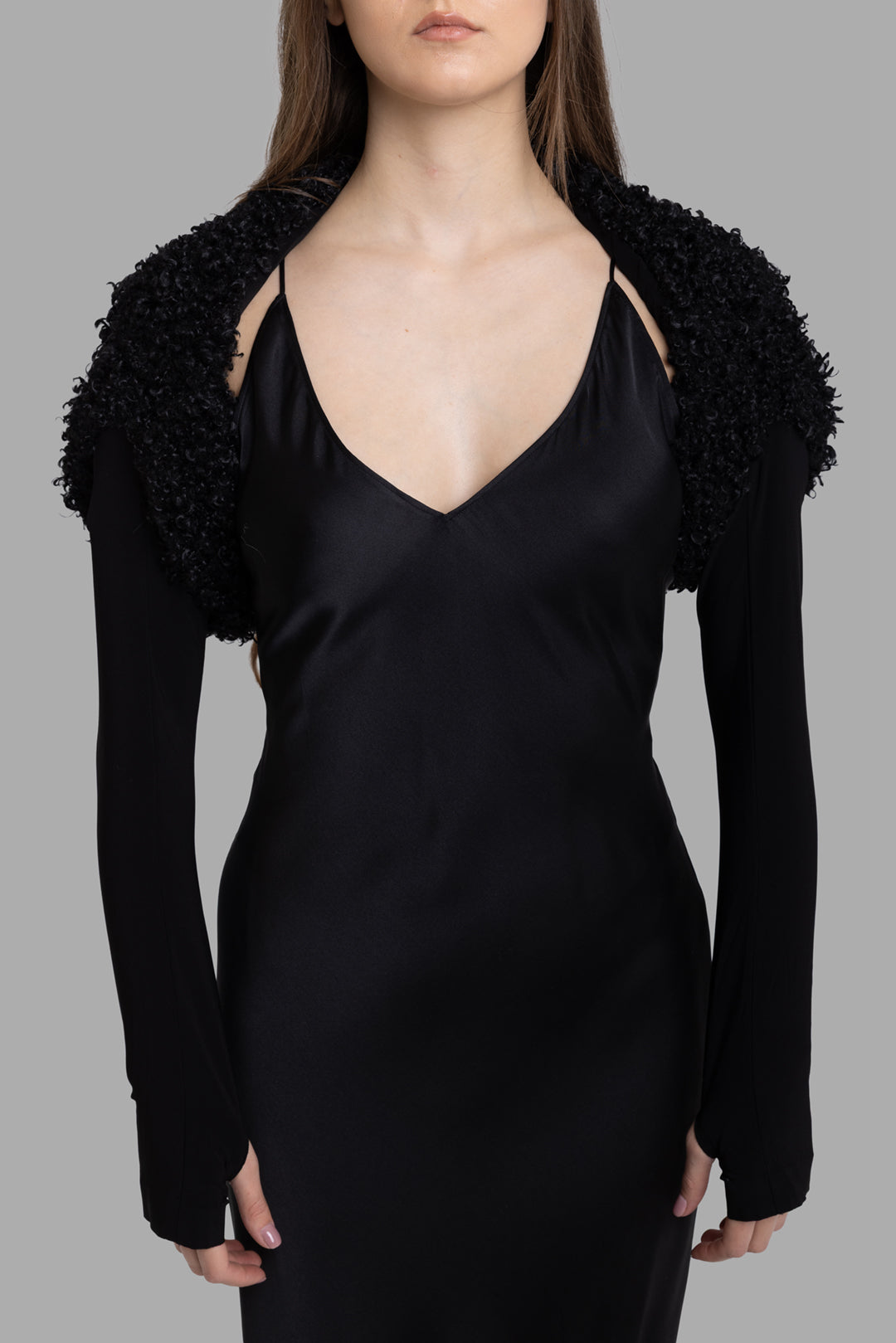 Norma Kamali women's black long sleeve shrug, front view, curly faux shearling shoulders and slim jersey arms.