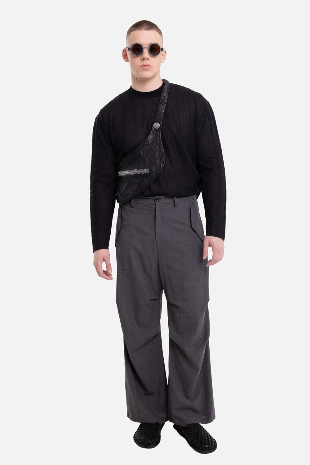 ATTACHMENT men's trousers in dark gray, on-model full-length view with wide leg and structured cargo shape