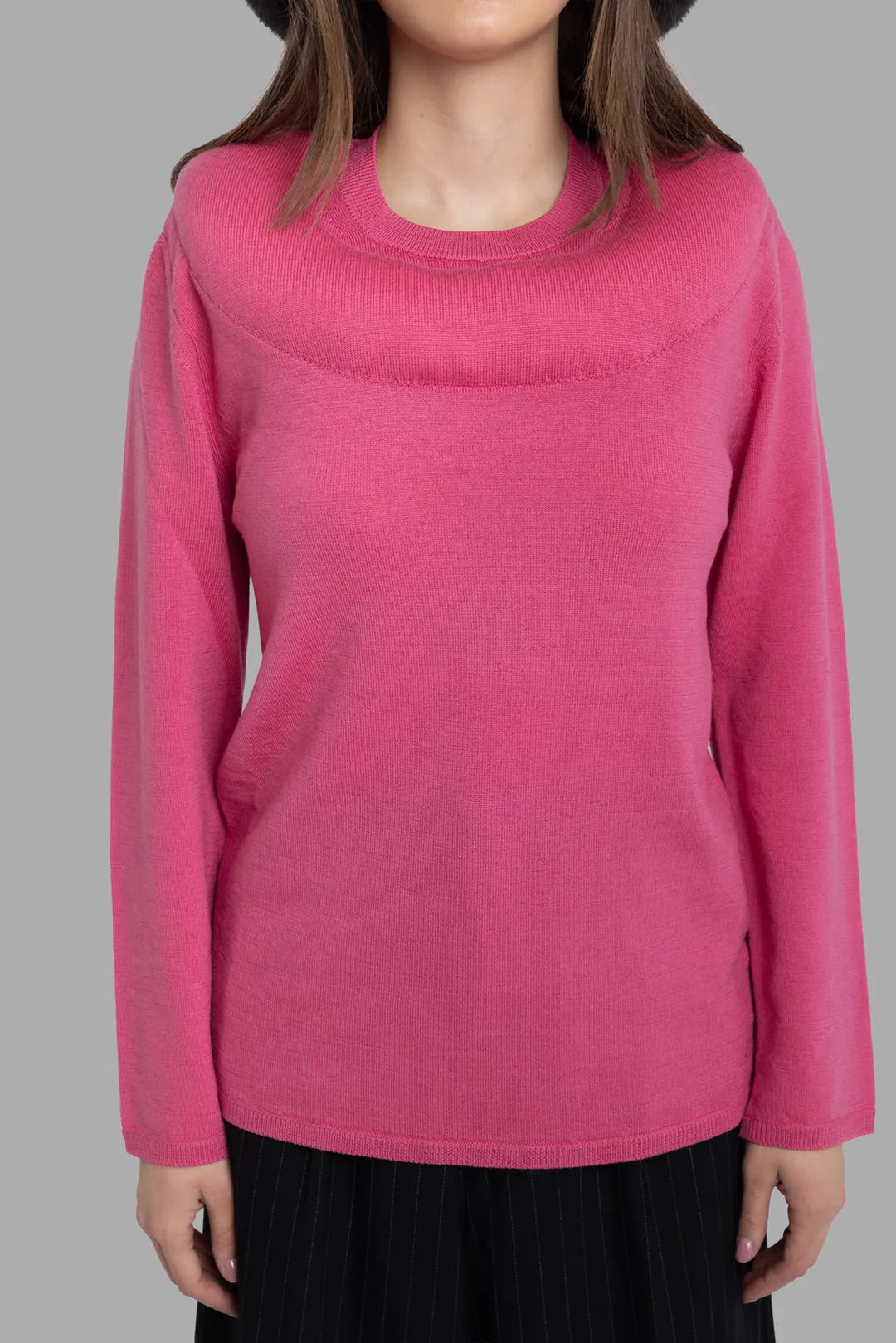 Comme des Garçons women's pink wool jumper, front view, wide yoke detail and long sleeves with fine knit texture.