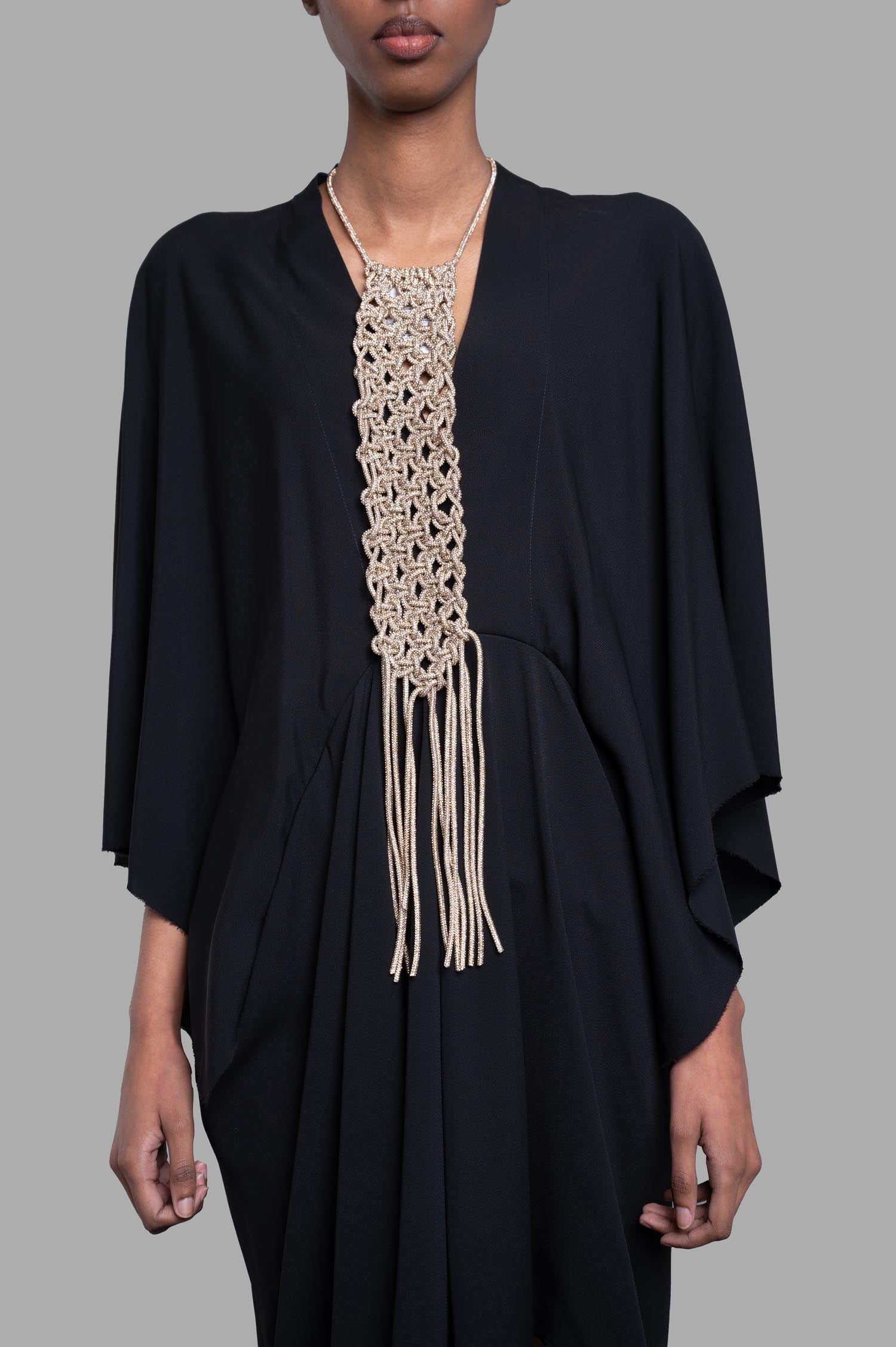Gentry Portofino Gold Macrame Necklace displayed on a model, showcasing intricate design and sparkling texture.