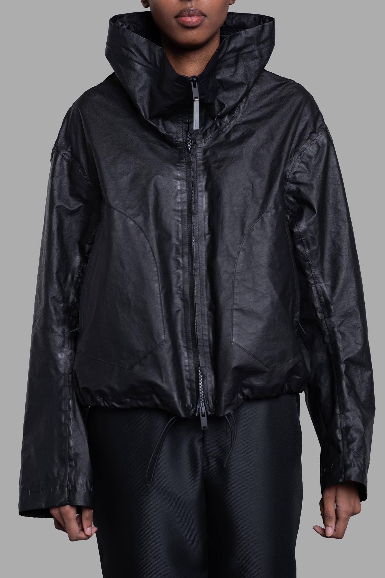 Isaac Sellam Cropped Windbreaker Jacket in black, showcasing tube neckline and zipper details, soft lambskin texture.