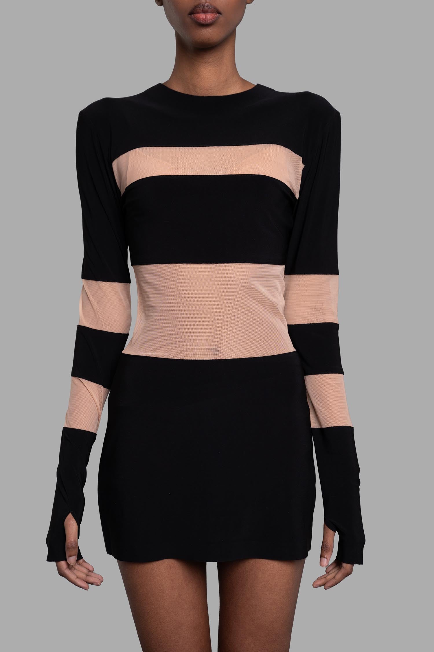 Norma Kamali. Spliced Pickleball Dress featuring a slim fit, long sleeves, and chic black mesh insets, modeled from the.