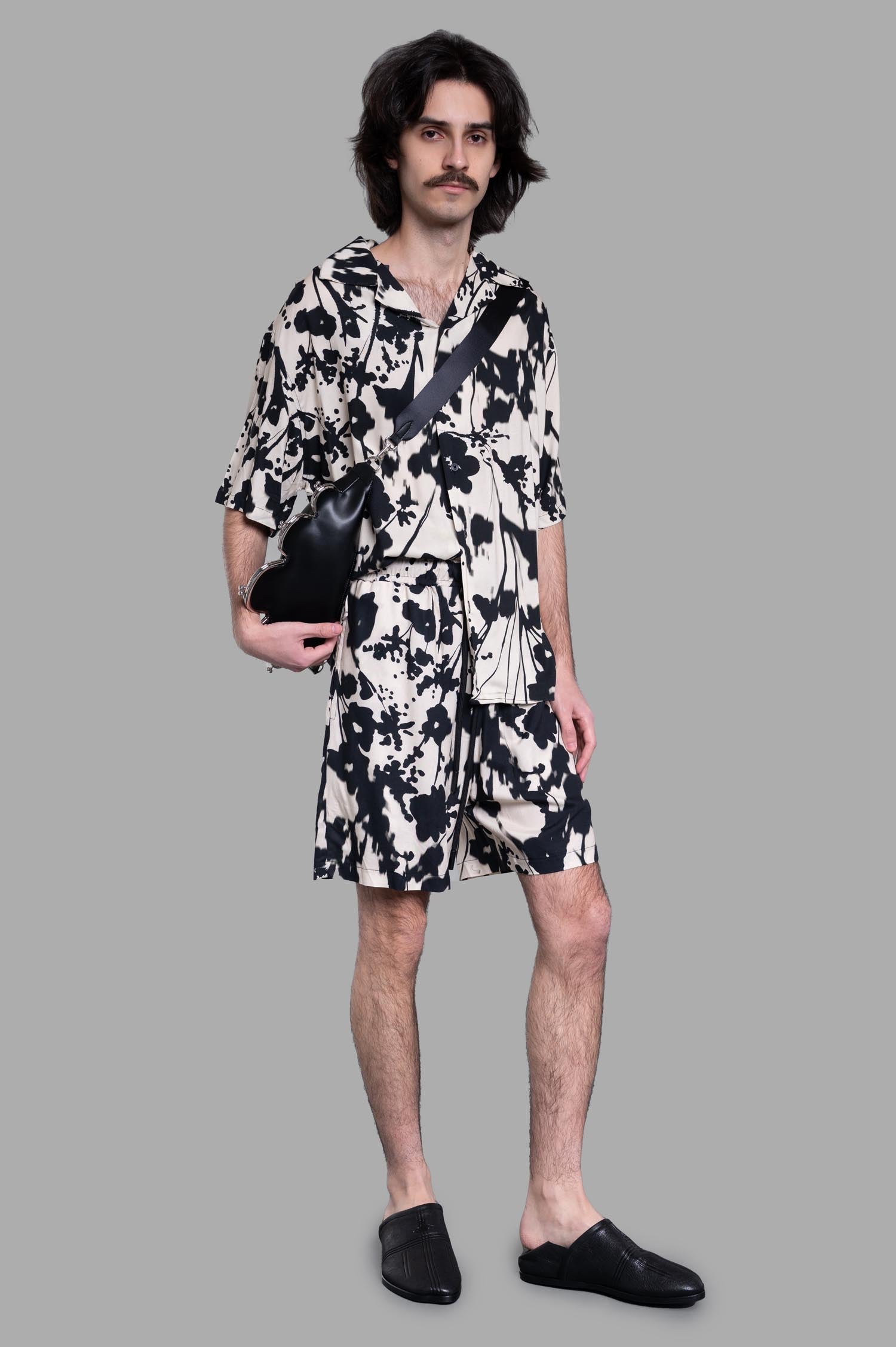 Gaëlle Paris Floral Shorts on-model, featuring a black and ecru floral design with matching floral shirt and black accessories.