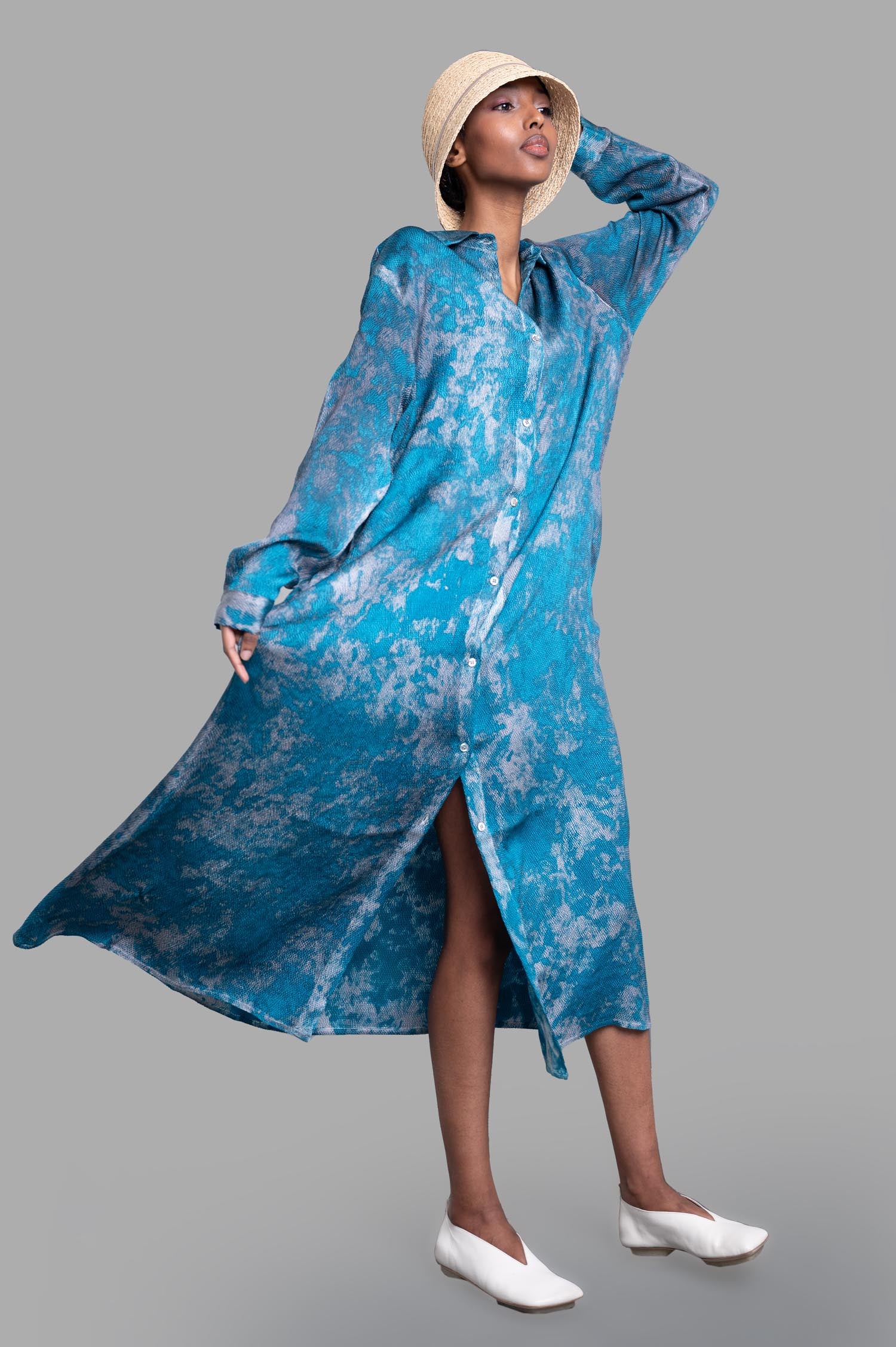 Avant Toi abstract-print shirt dress, front view on-model, blue pattern, styled with a hat and white shoes.