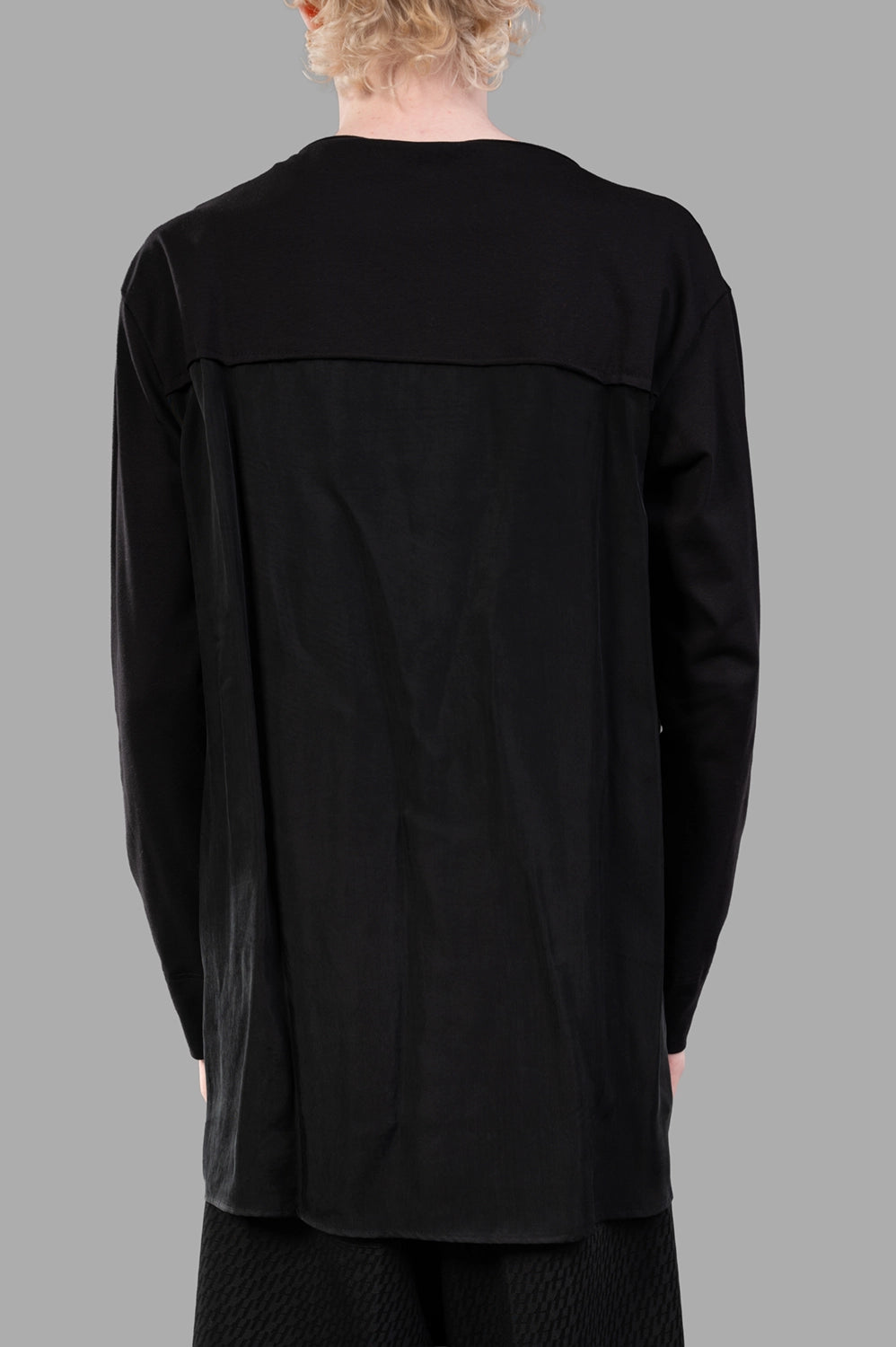 Back close-up of extended woven yoke panel and clean longline hem