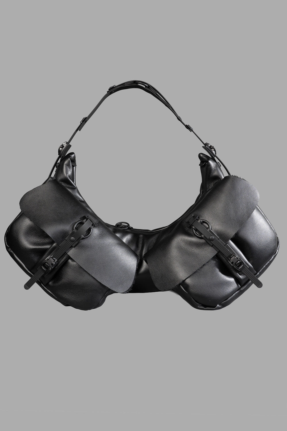 Full-length view of half-moon shoulder bag in black matt with twin flap pockets, adjustable strap, top zip.