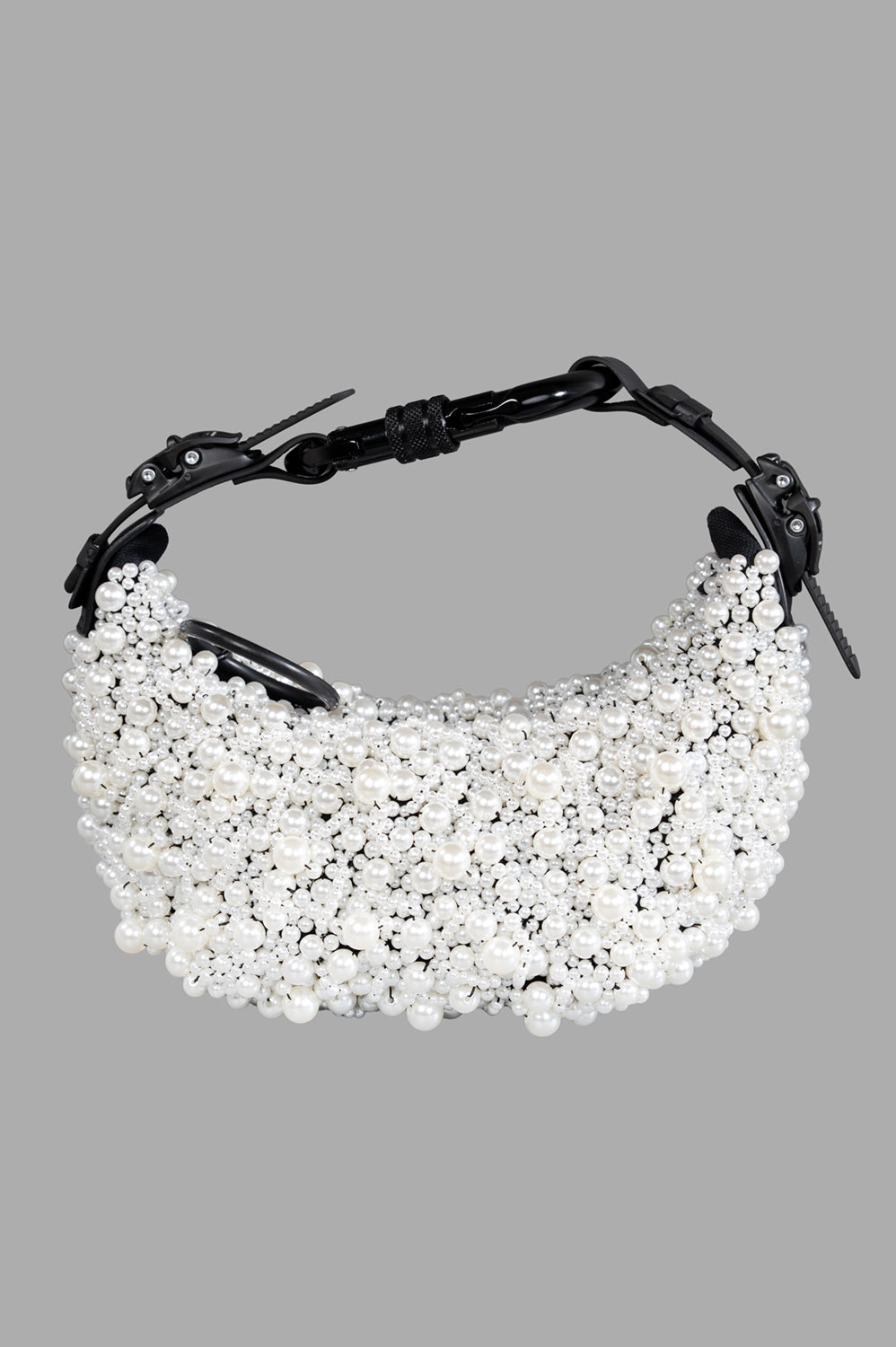 Full-length view of pearl-embellished half moon bag in white with black matte hardware and carabiner shoulder strap.