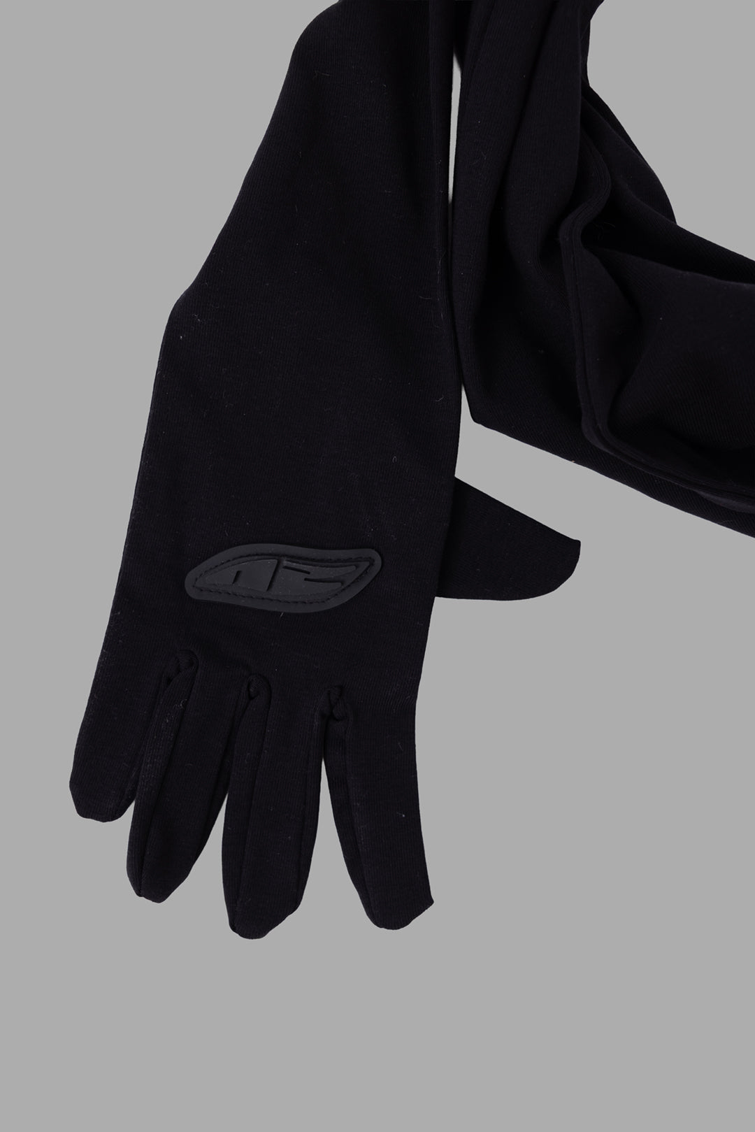Natasha Zinko unisex black hands scarf, close-up of glove with tonal logo patch on back of hand