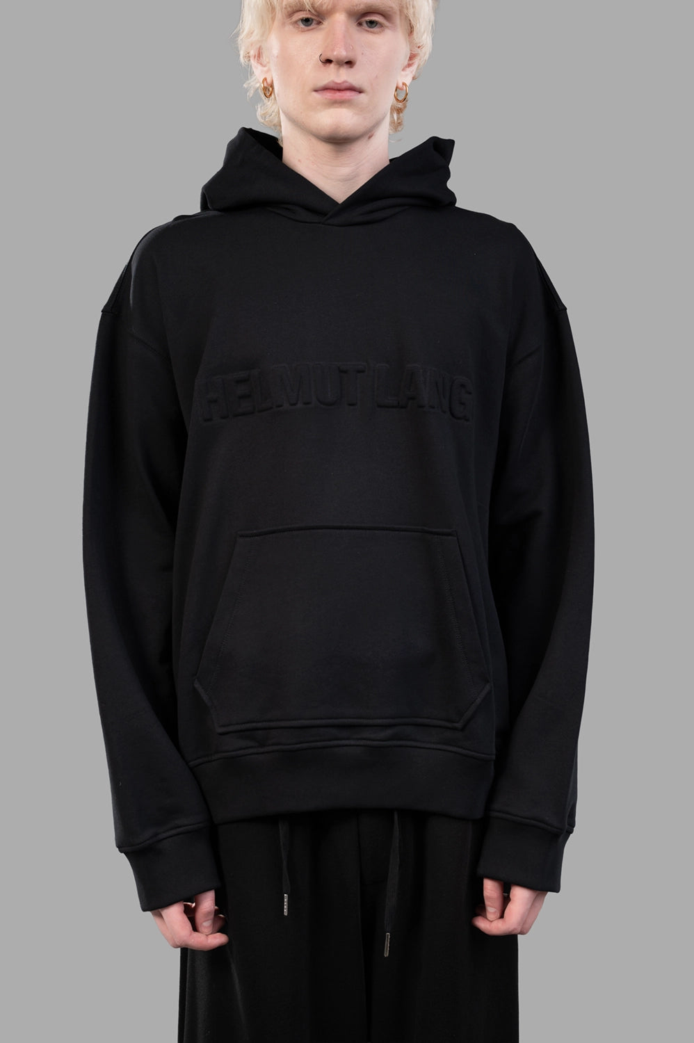 Back view of black hoodie with relaxed drop shoulders and roomy hood