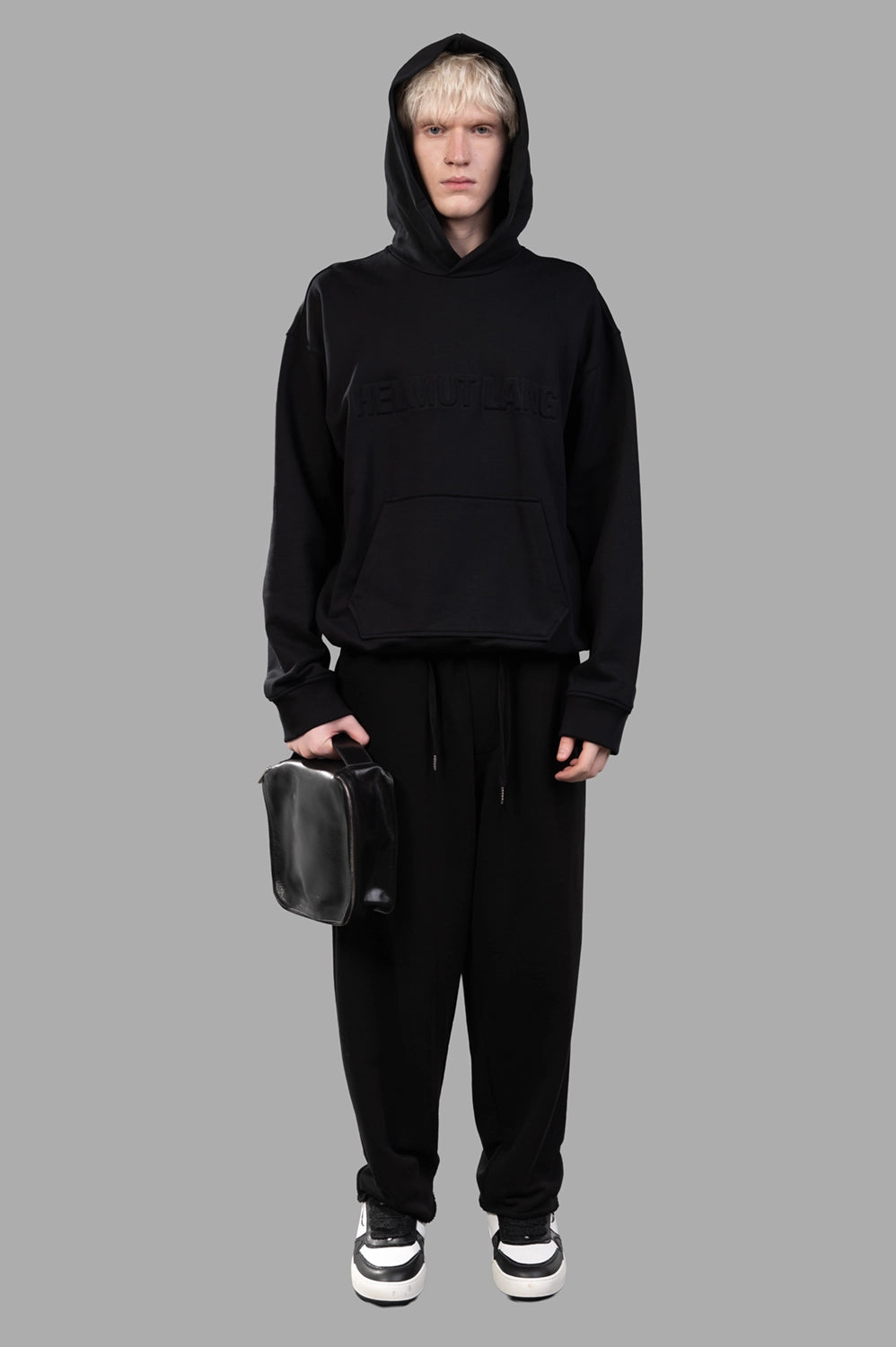 Full-length black hoodie with embossed front logo, kangaroo pocket and ribbed trims