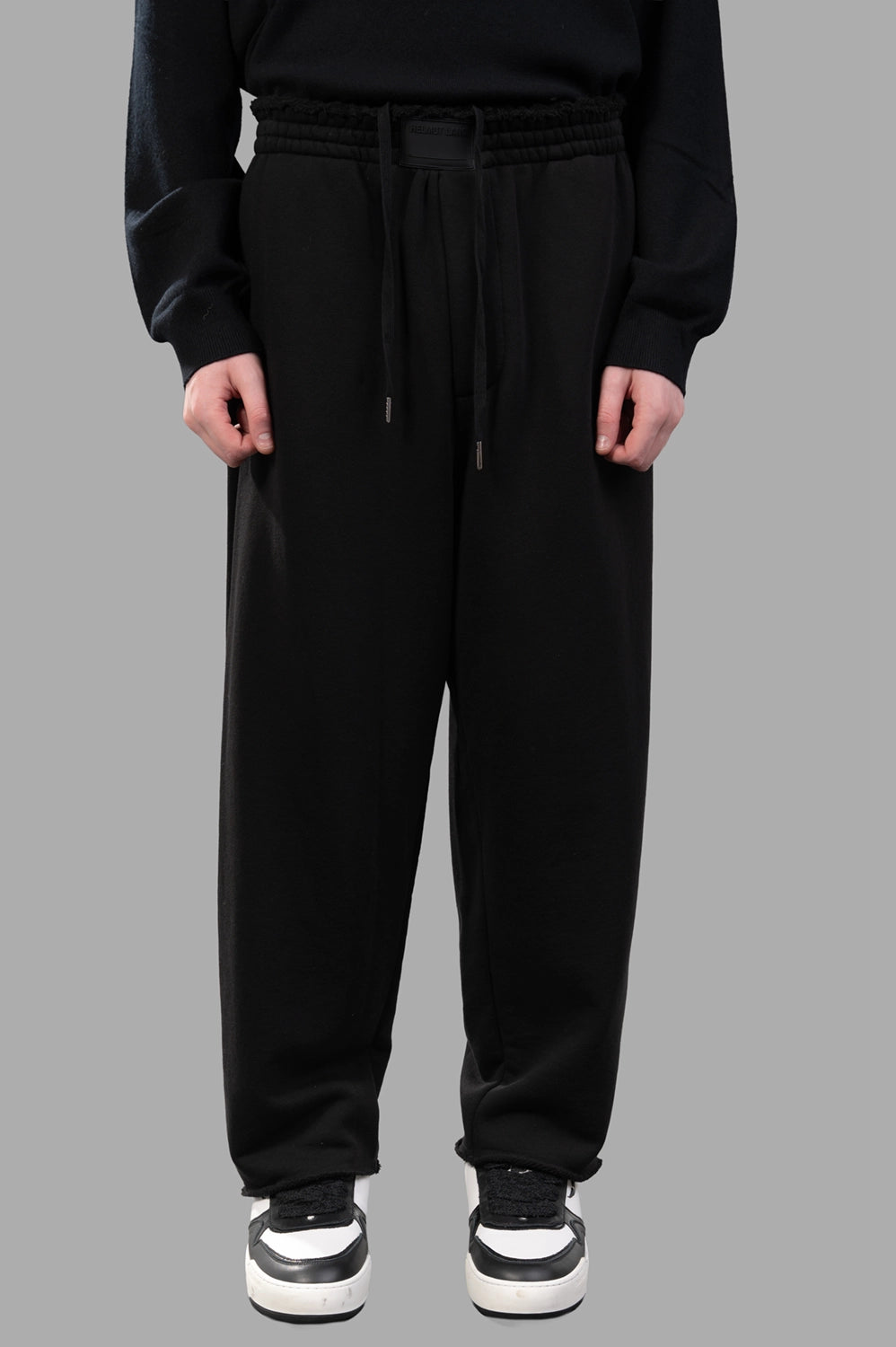 Back view of sweatpants with patch pockets and relaxed drape
