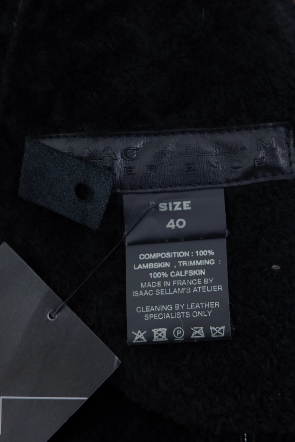 Pre-owned Isaac Sellam leather jacket in black, interior label close-up, size and composition tag
