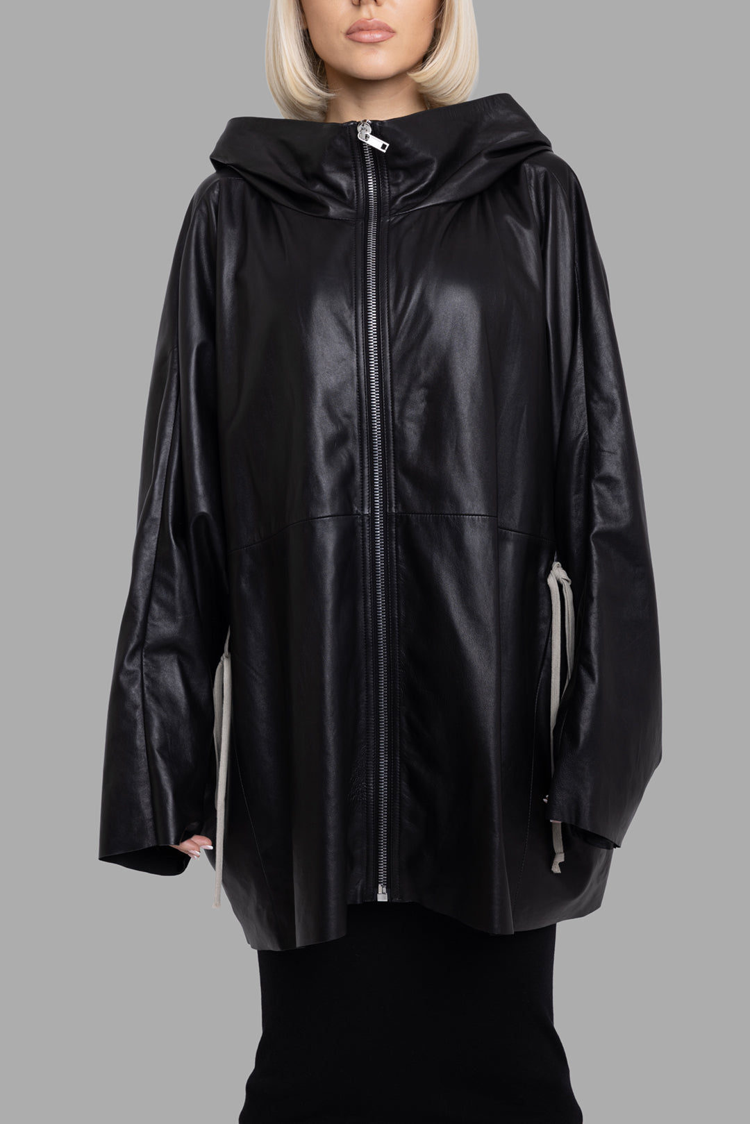 Rick Owens women's black hooded leather jacket, front view highlighting wide sleeves, two-way zip and side drawcord detail.