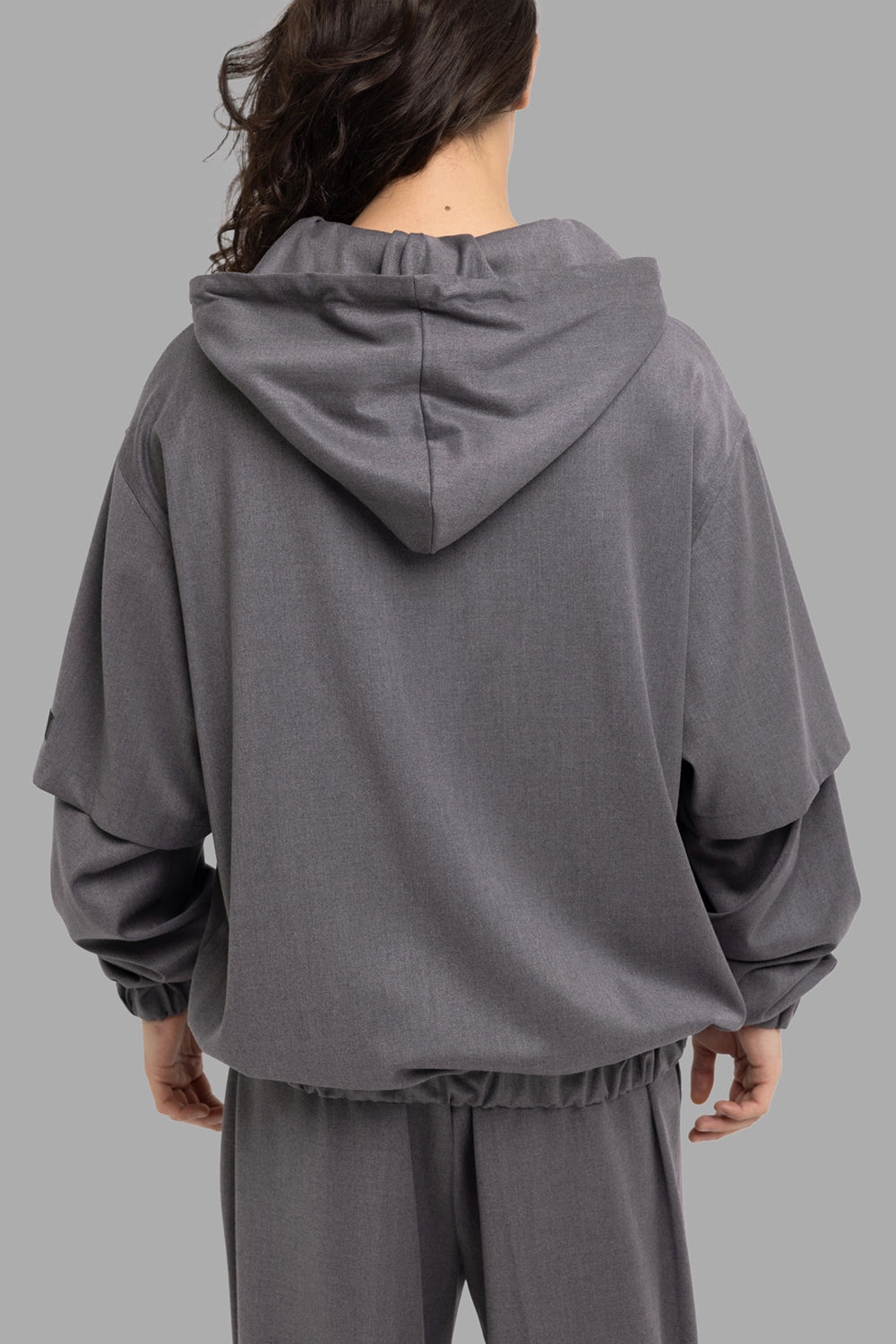 Gaëlle Paris men's hooded overshirt in black, back view, roomy hood and gathered hem